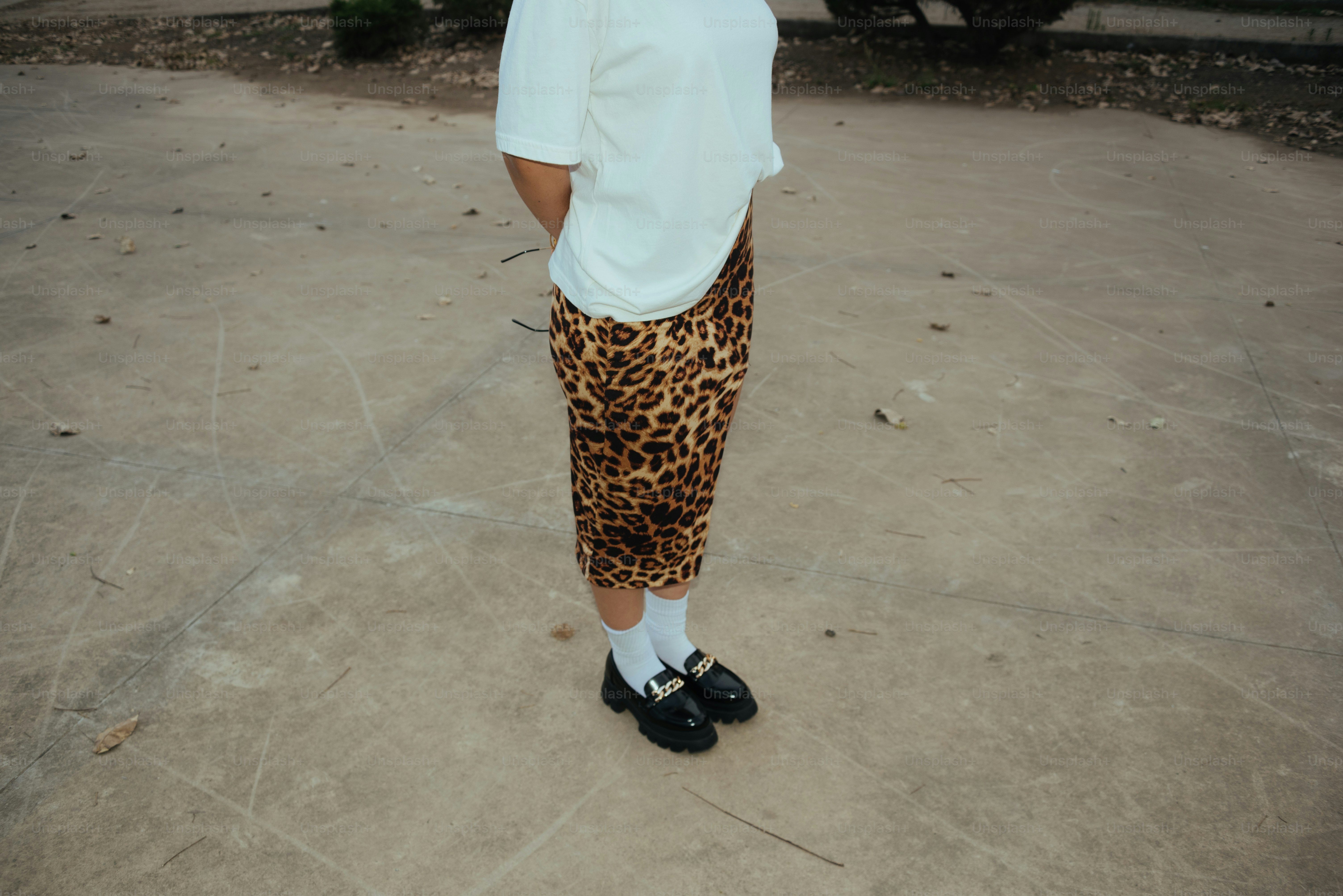 A man in a white shirt and leopard print pants