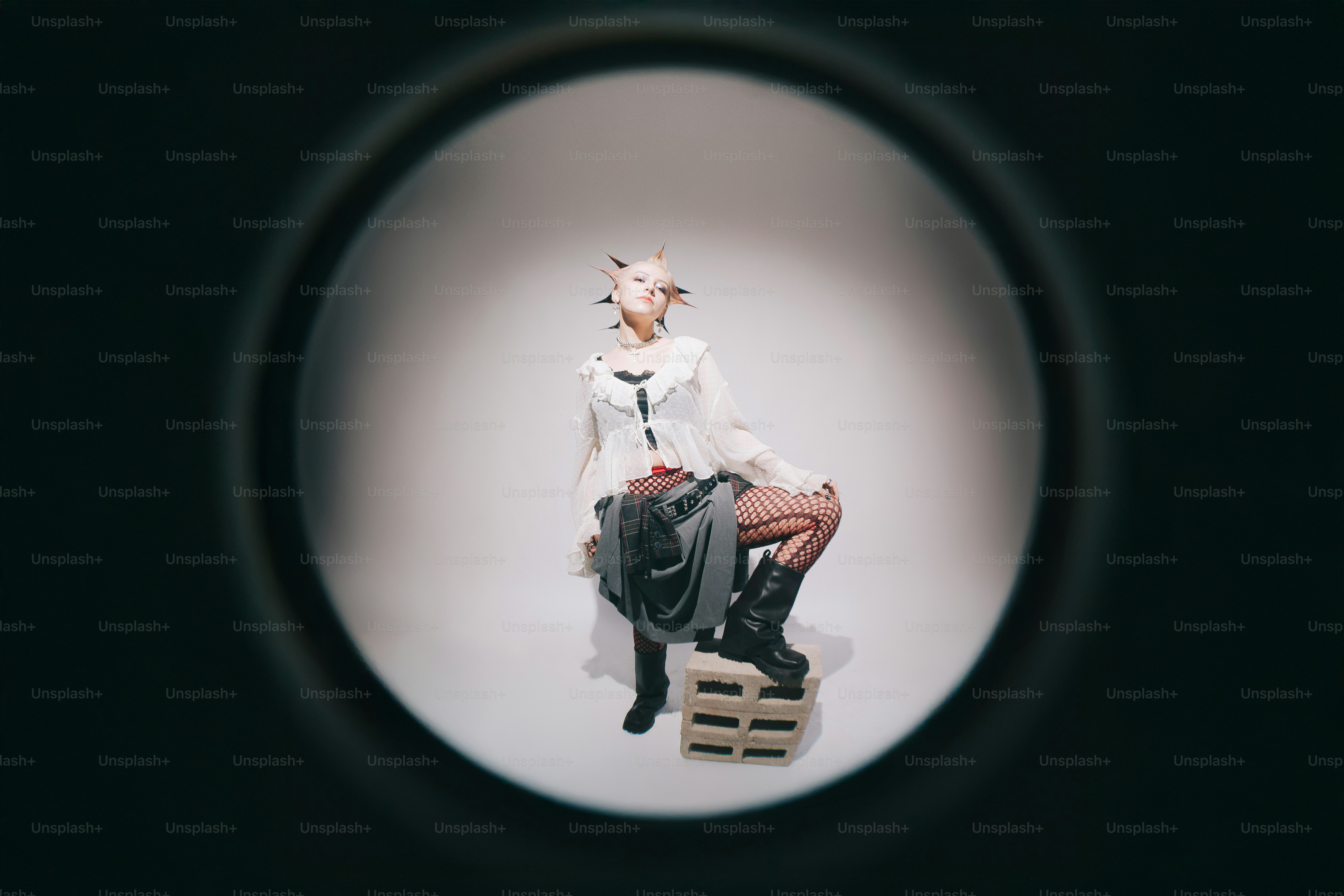 A person sitting on a wooden box in a circle