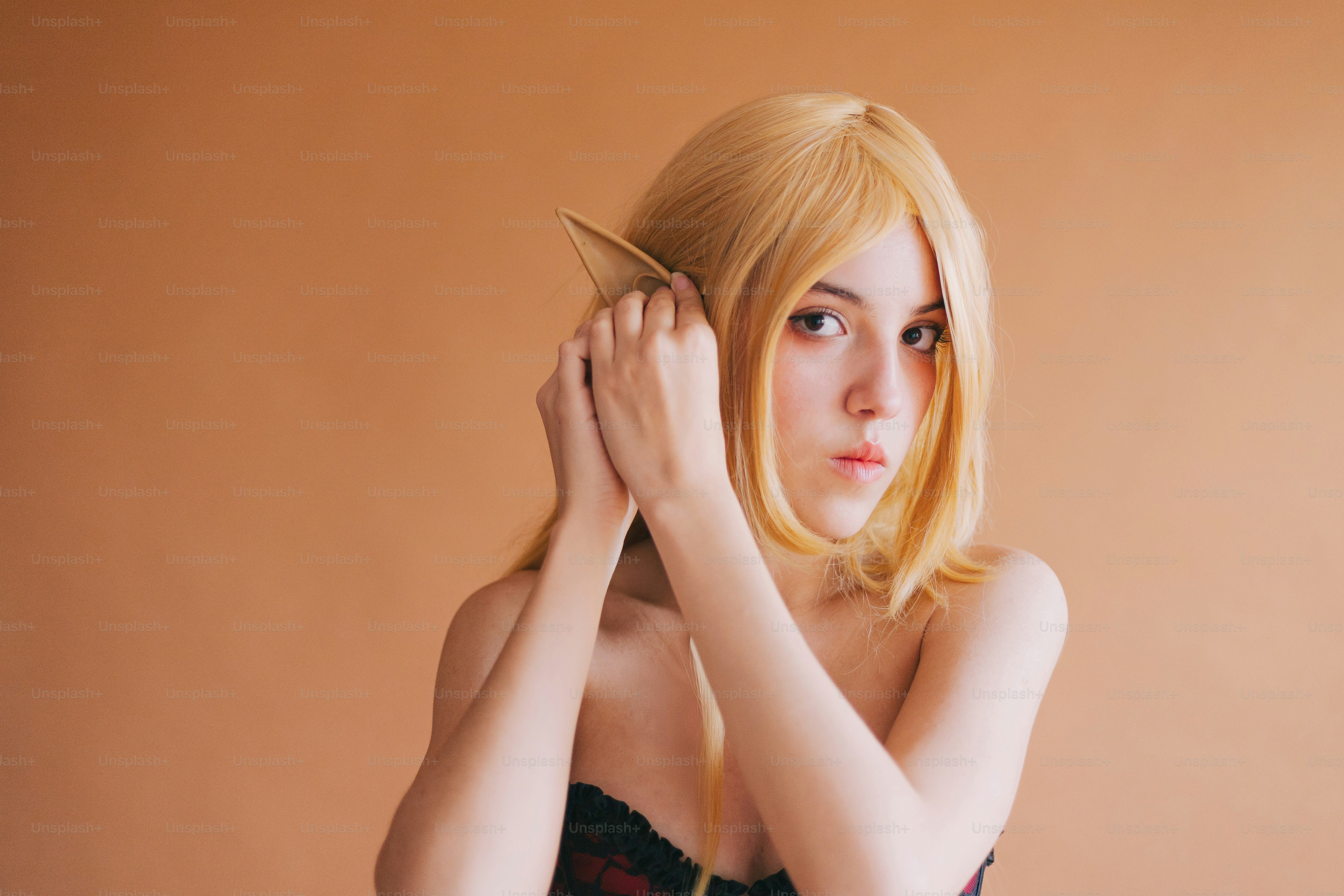 A woman with blonde hair is holding a comb