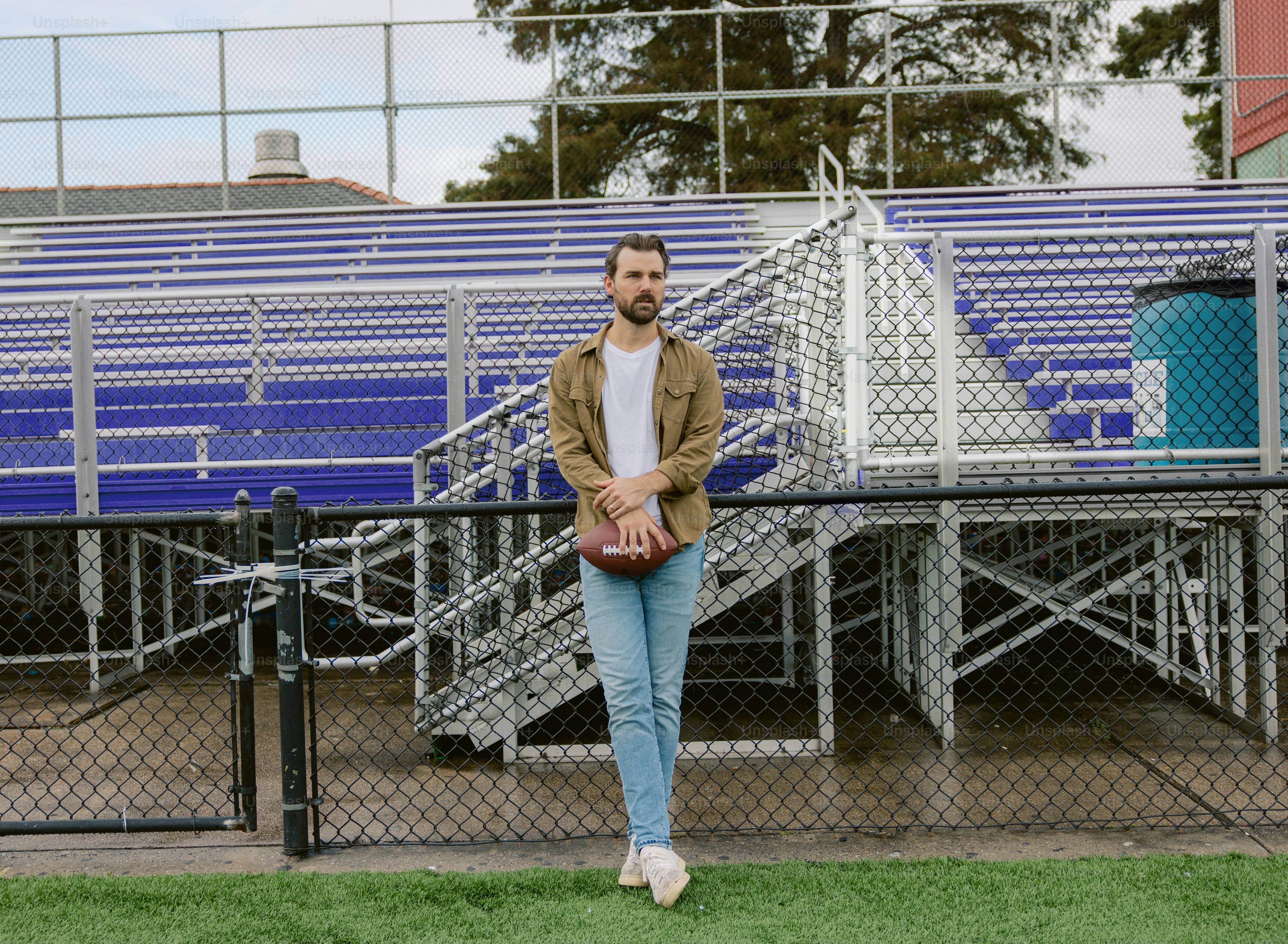 A man standing in front of a football field