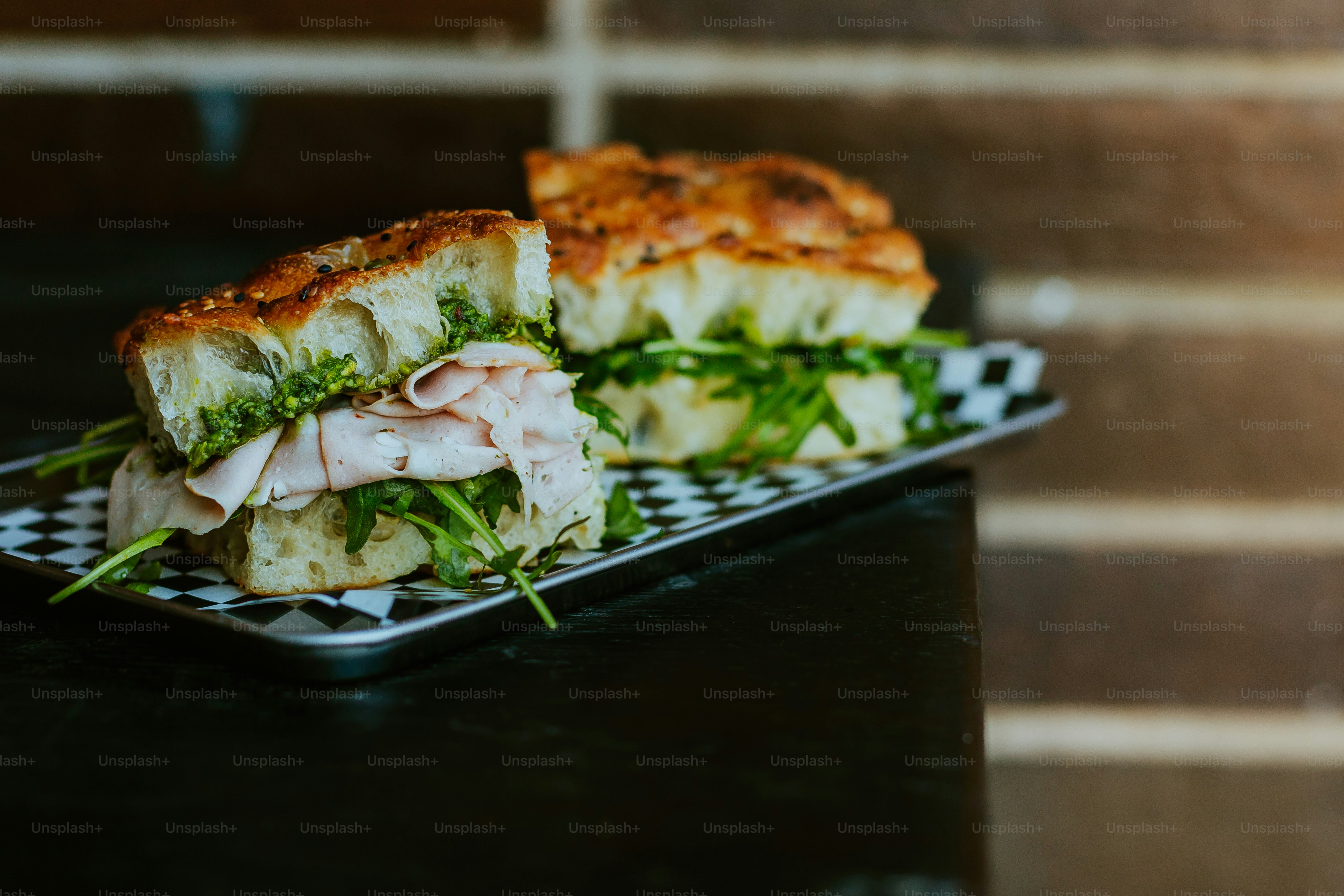 A sandwich cut in half sitting on top of a plate