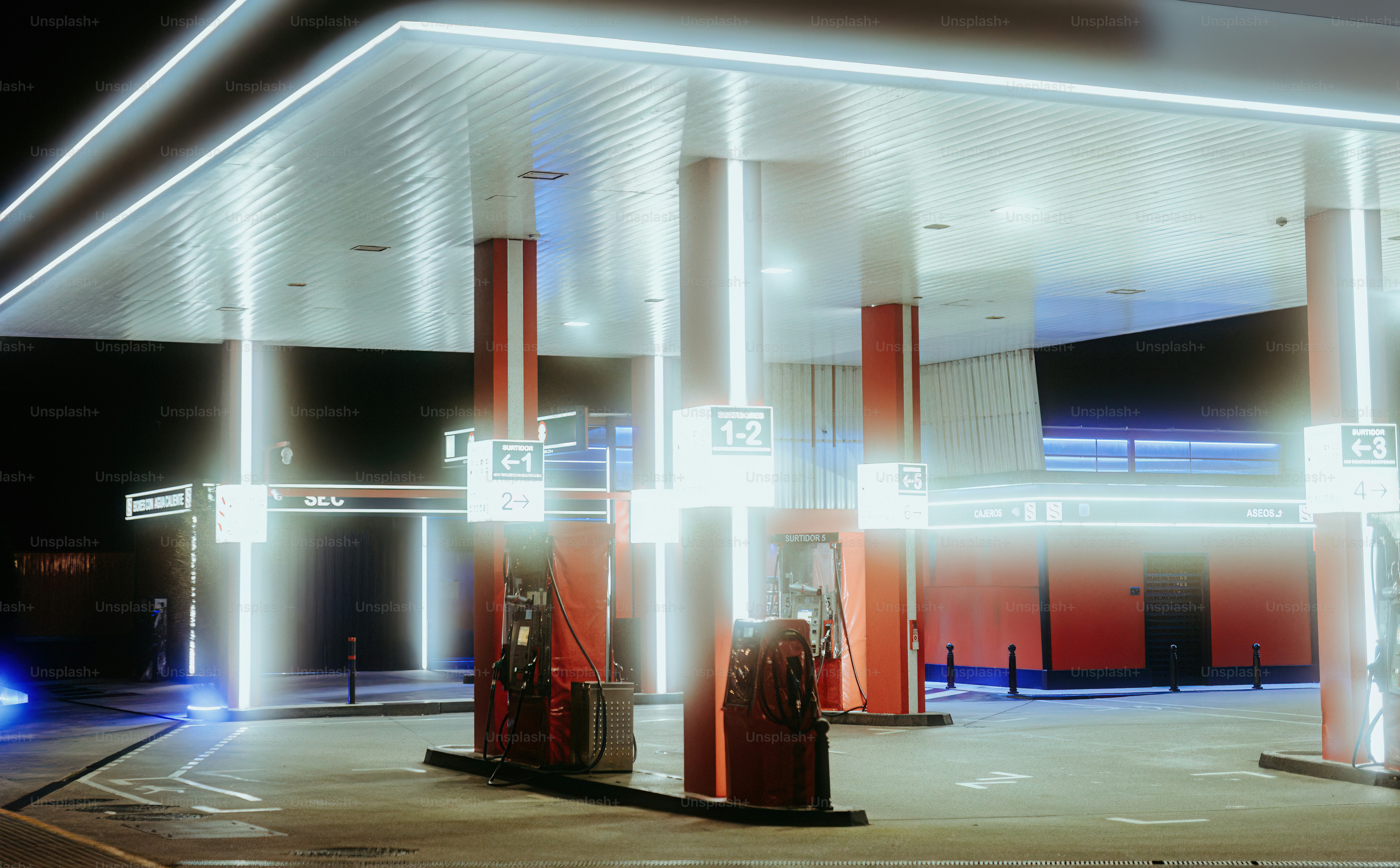 A gas station lit up at night time