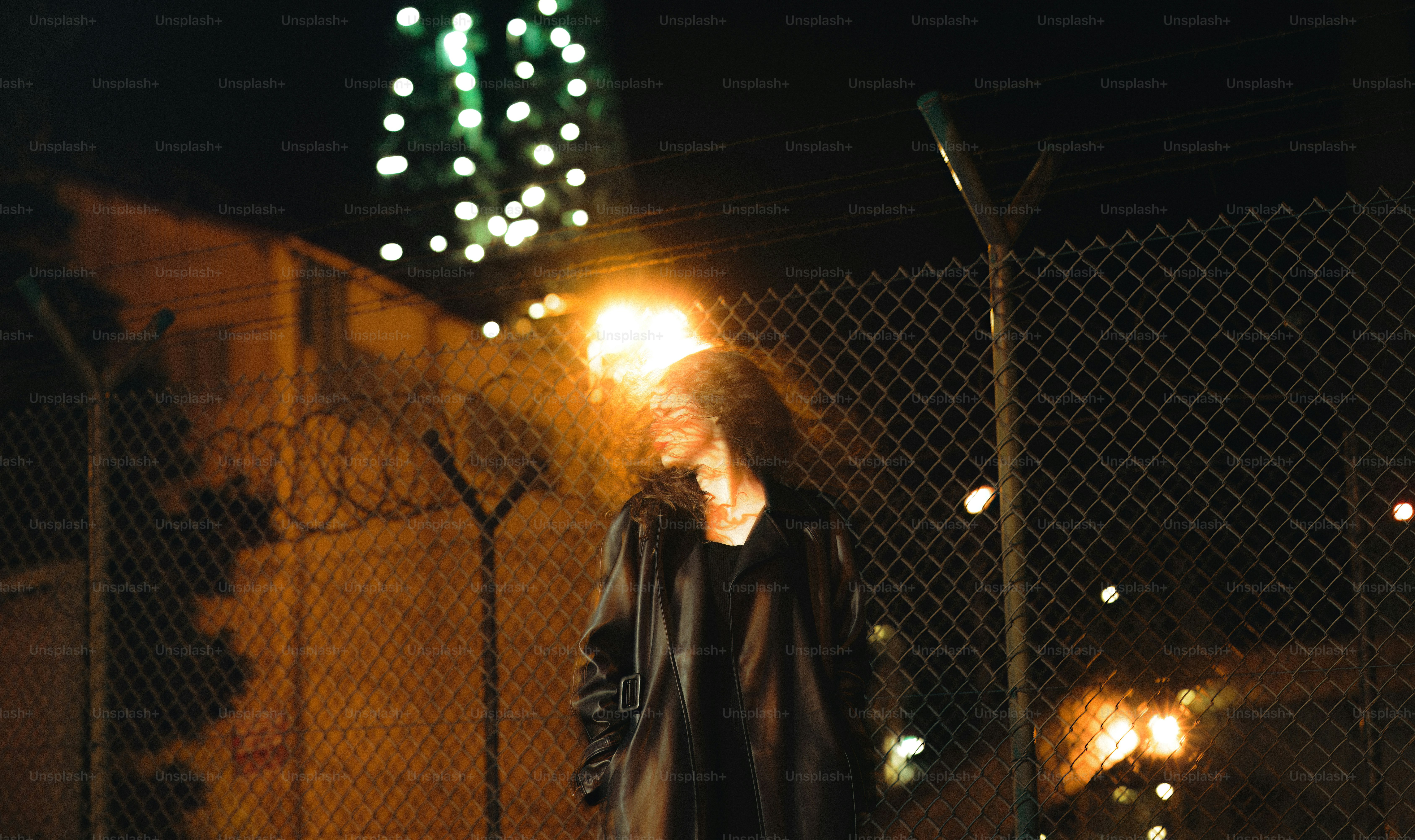 A man standing in the middle of a street at night photo – City Image on ...