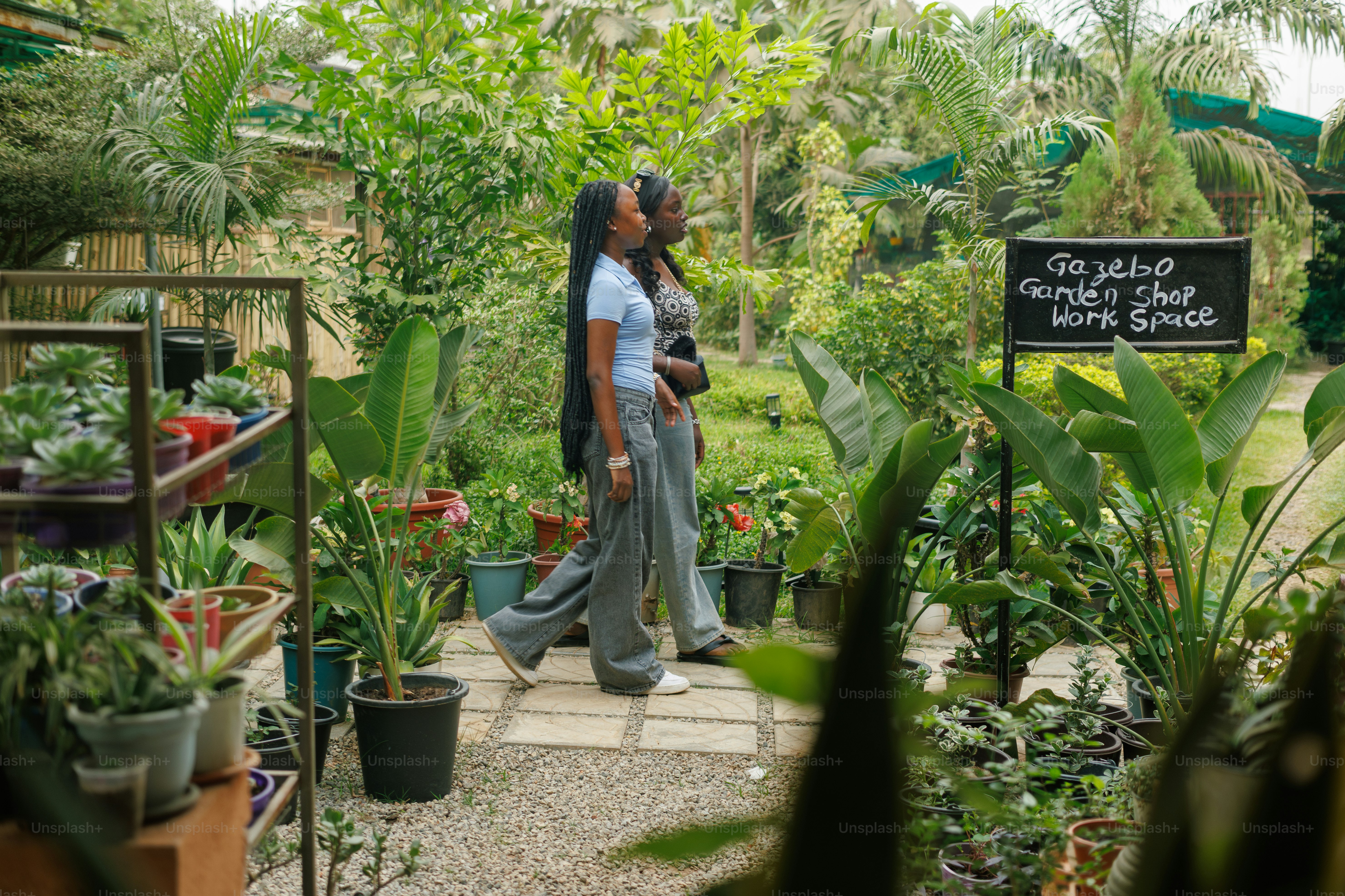 A couple of women standing next to each other in a garden