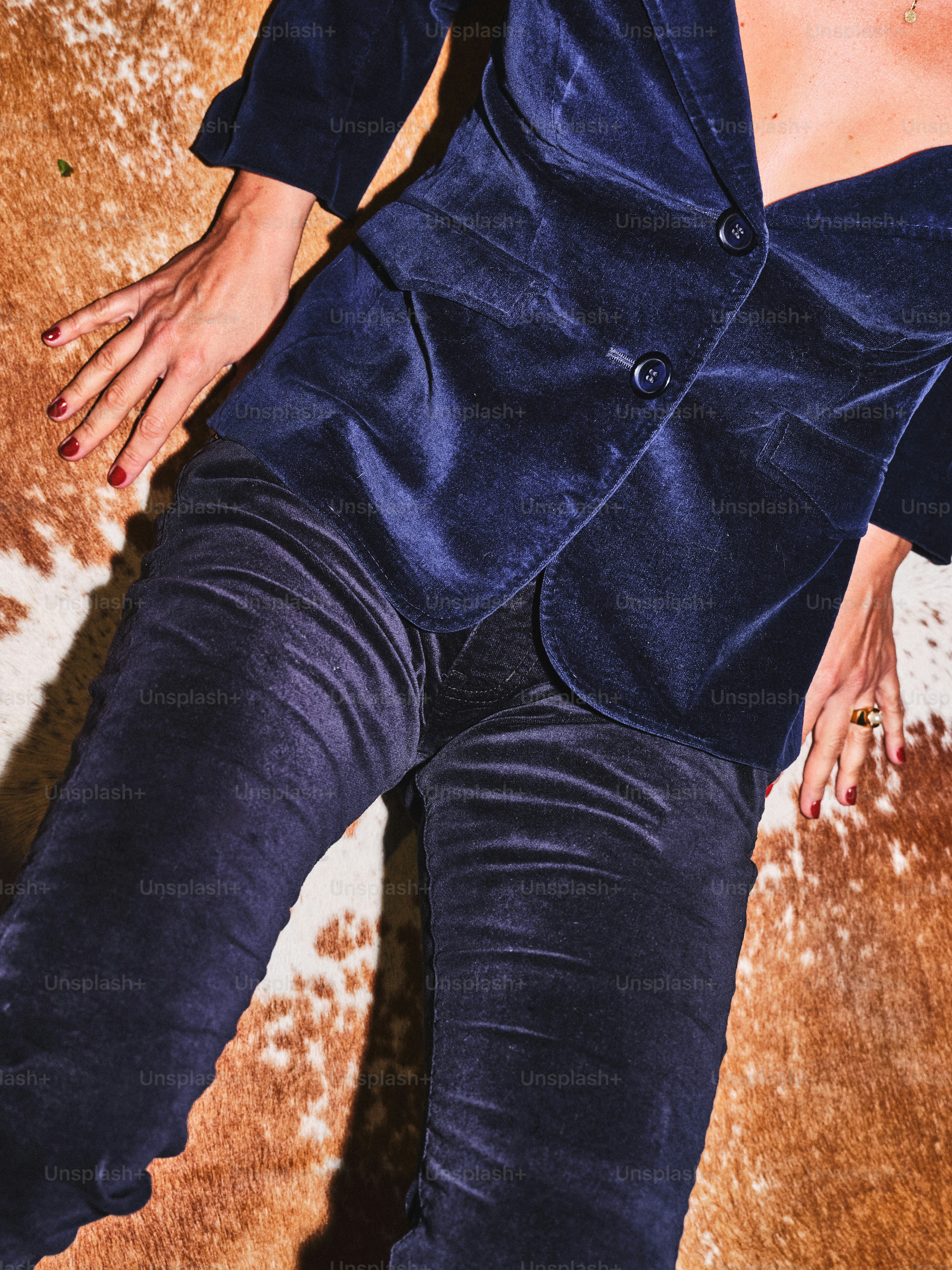 A woman laying on the ground in a blue suit