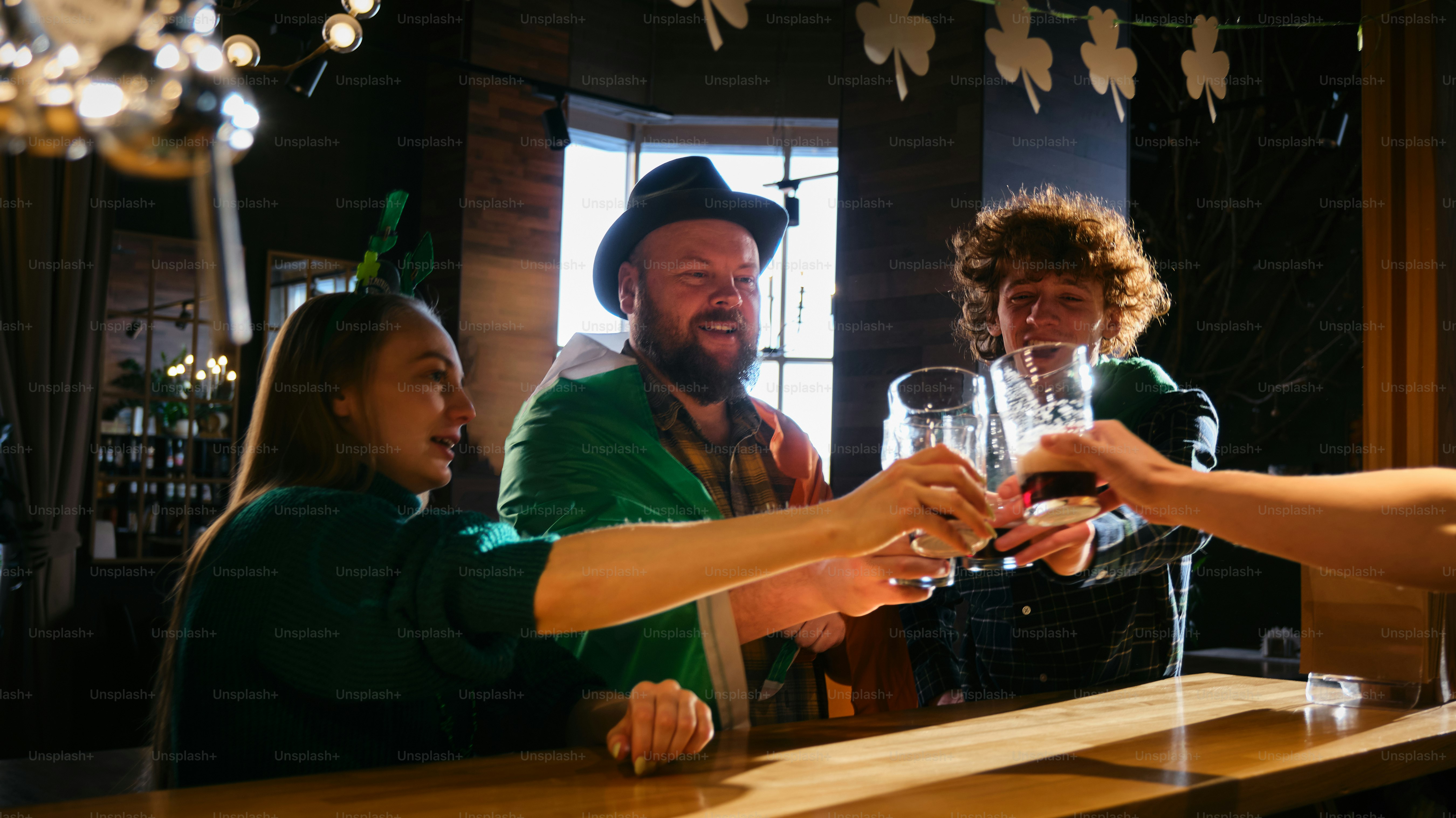 A group of people standing around a bar holding wine glasses