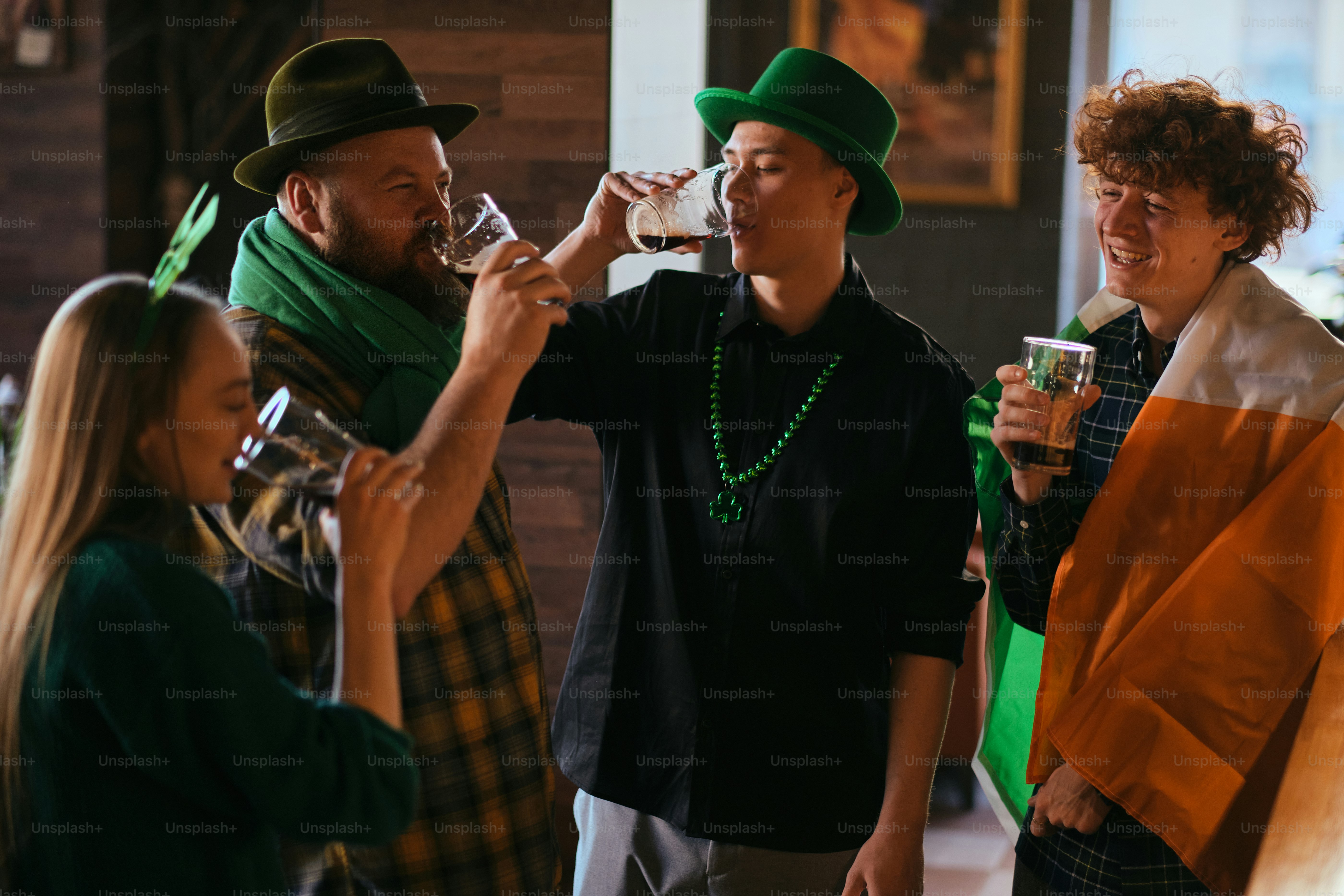 A group of people standing around each other drinking