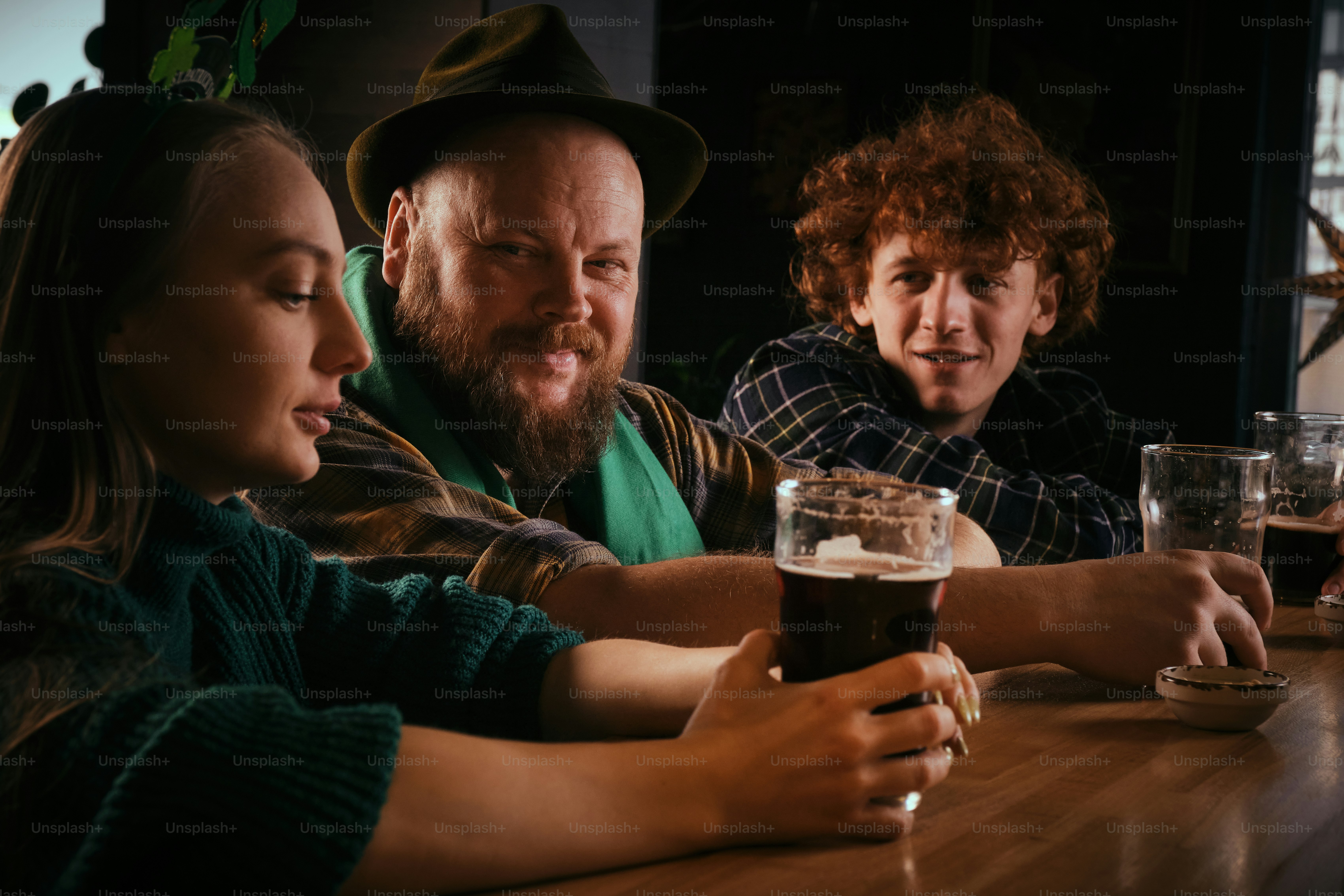 A group of people sitting at a table drinking beer