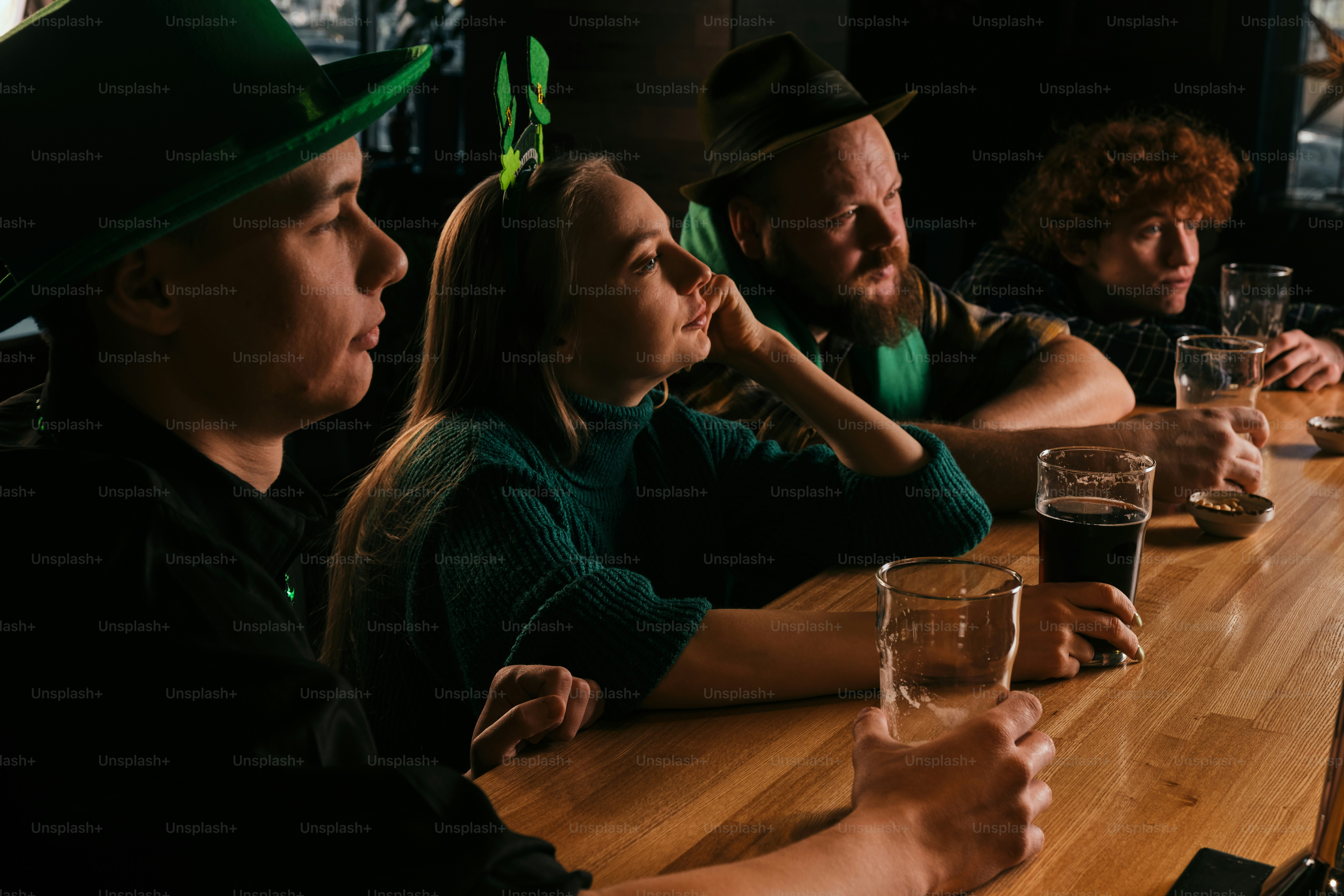 A group of people sitting at a table with beers
