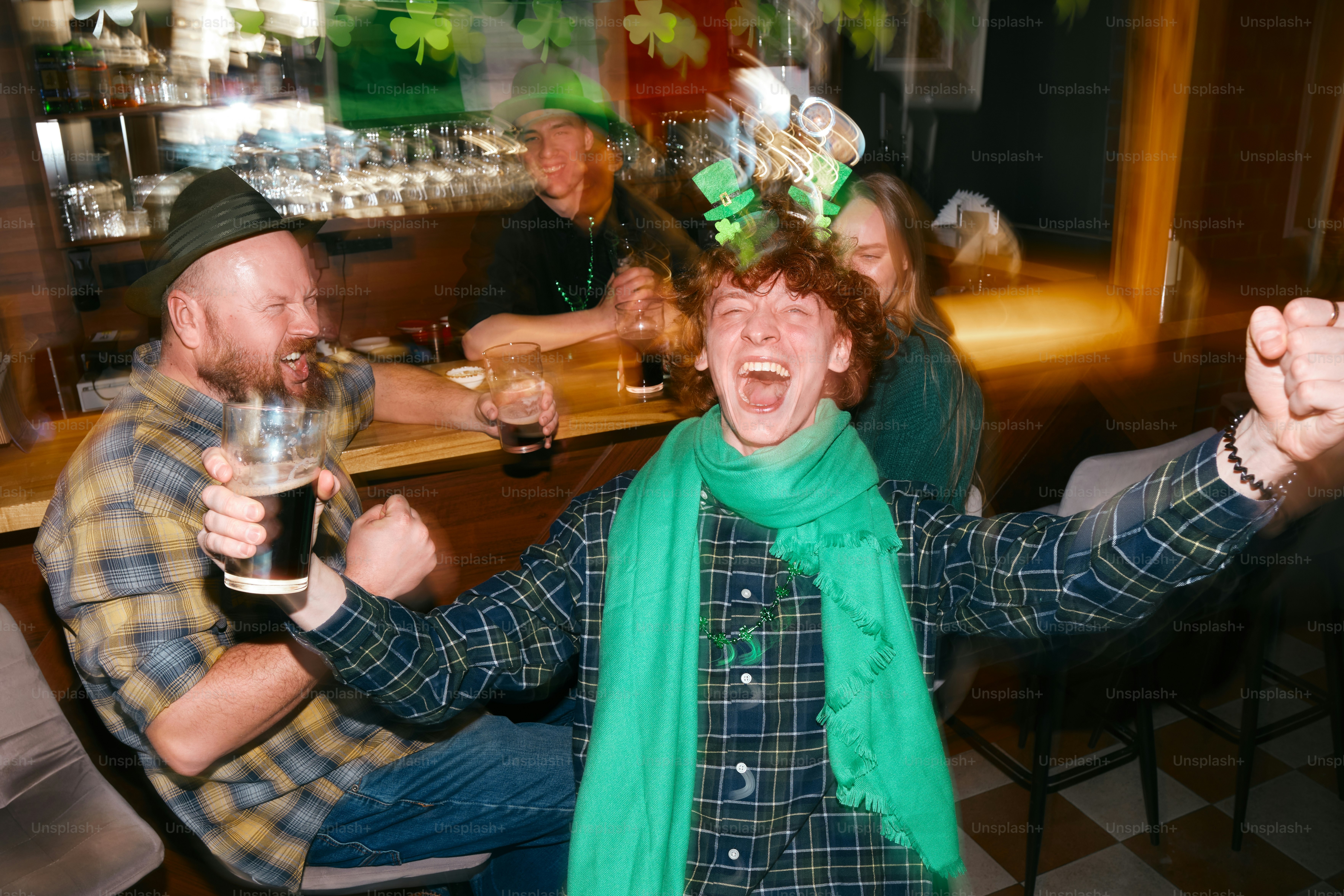 A company of friends in Irish pub with St Patrick’s outfits and decorations