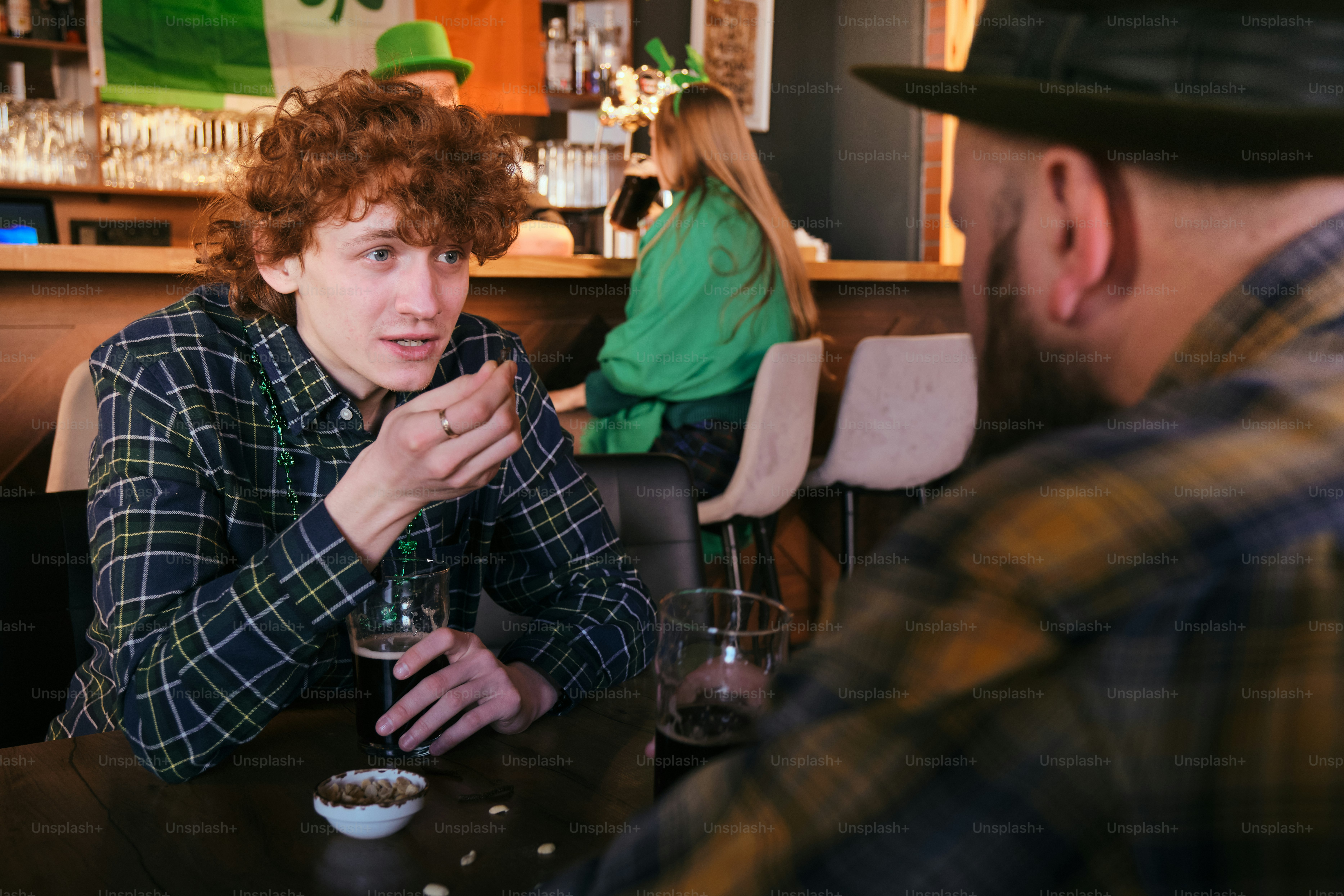 A man sitting at a table talking to a woman