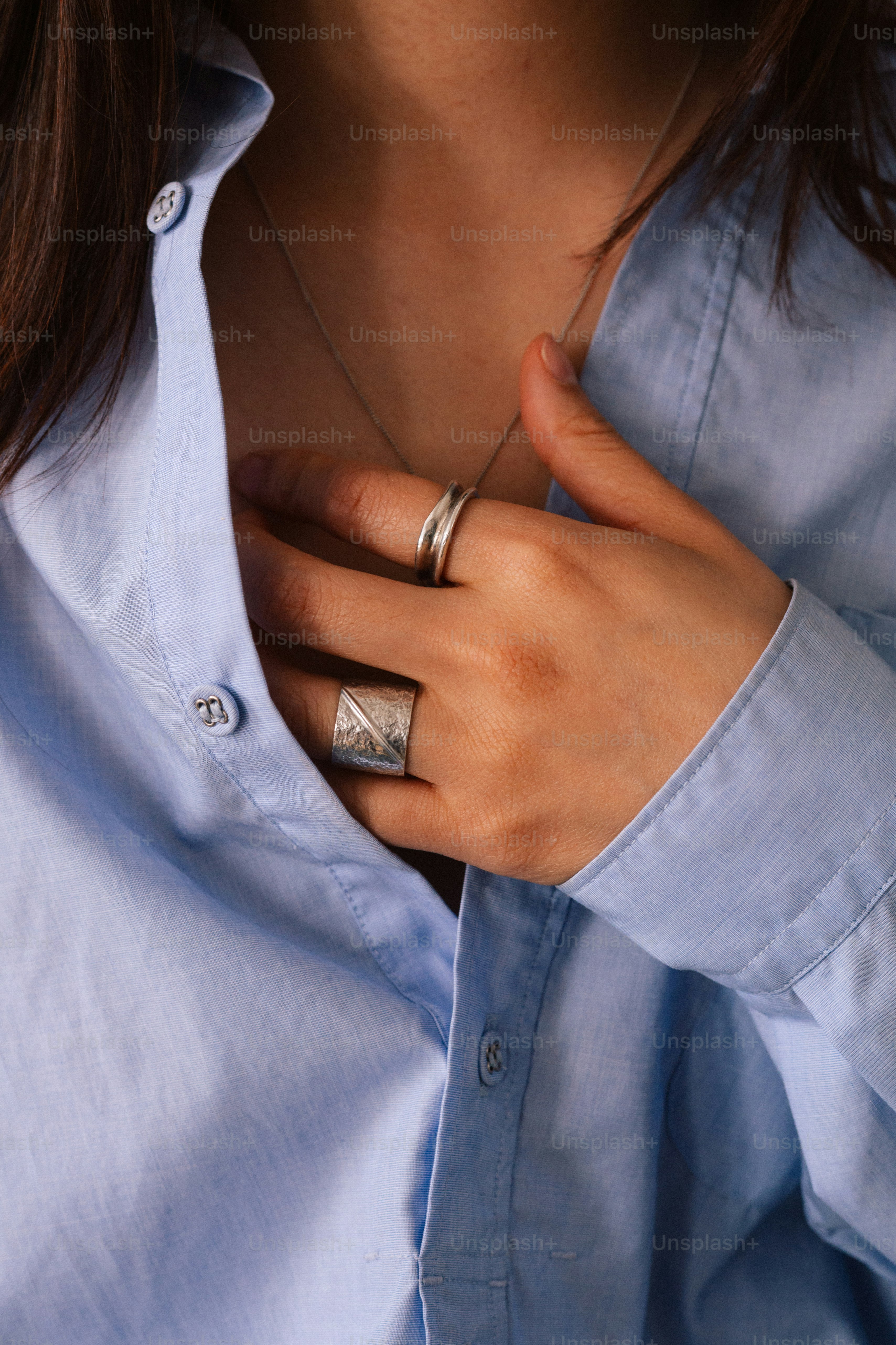 A close up of a person wearing a blue shirt