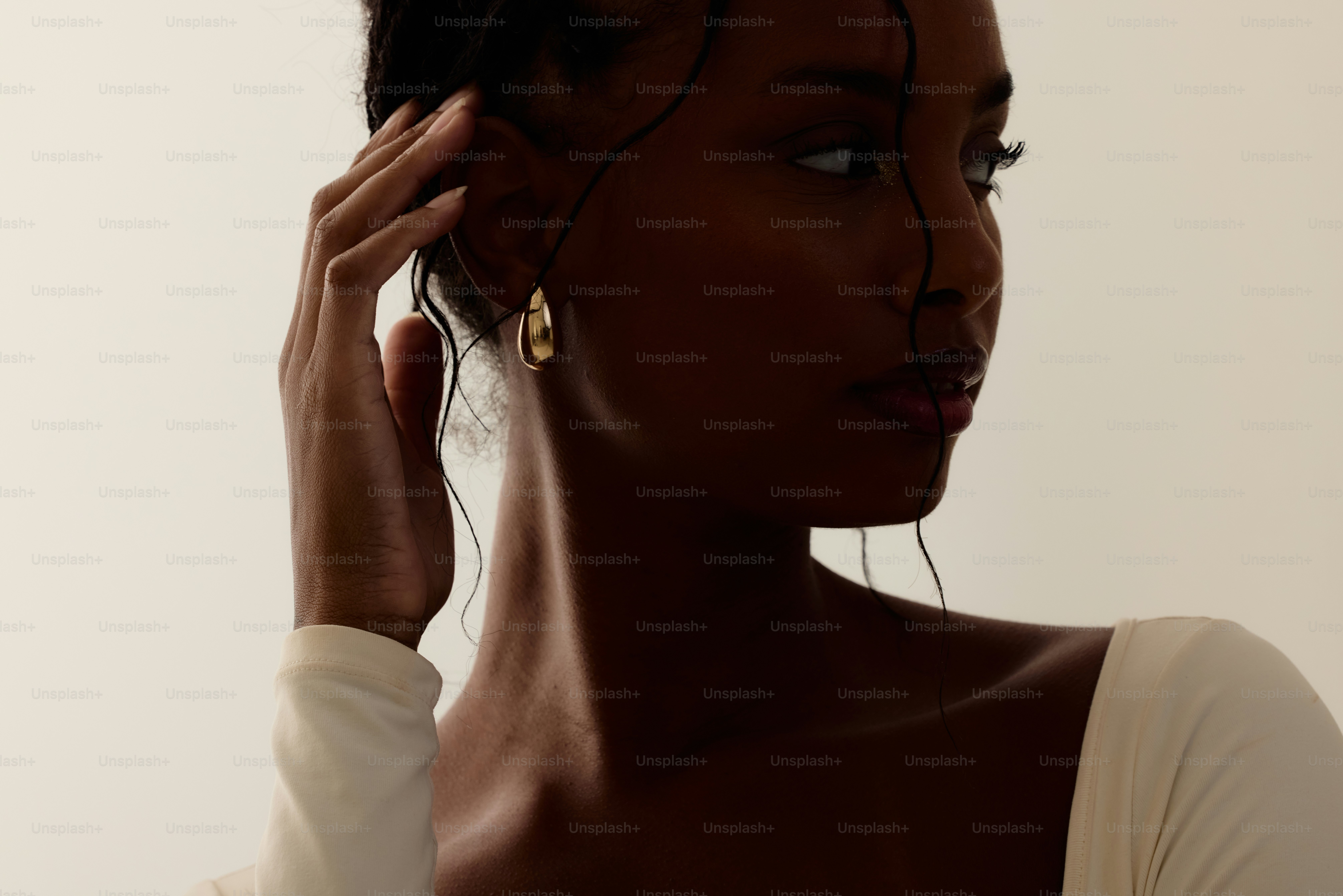 A woman in a white shirt is talking on a cell phone