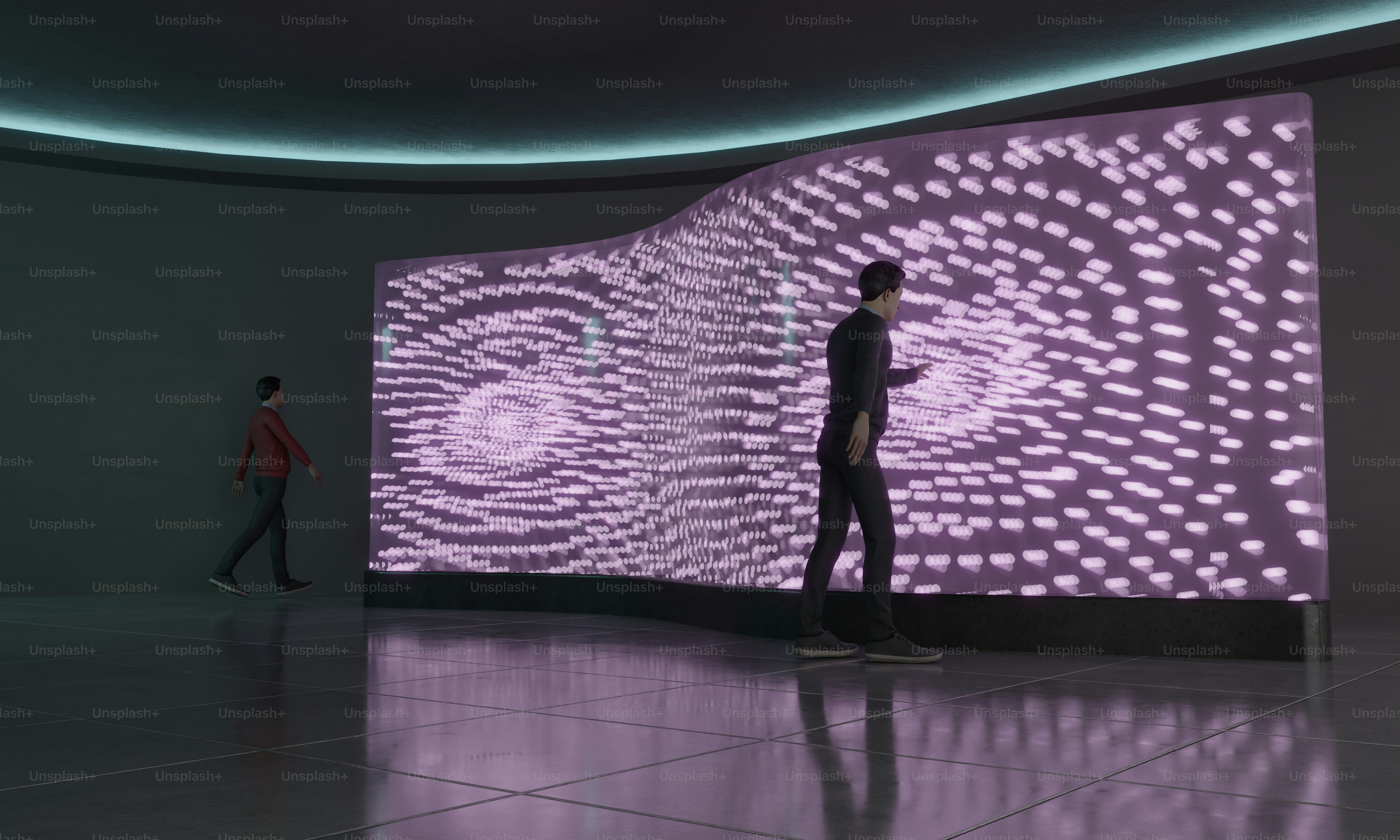 Two people standing in front of a large screen