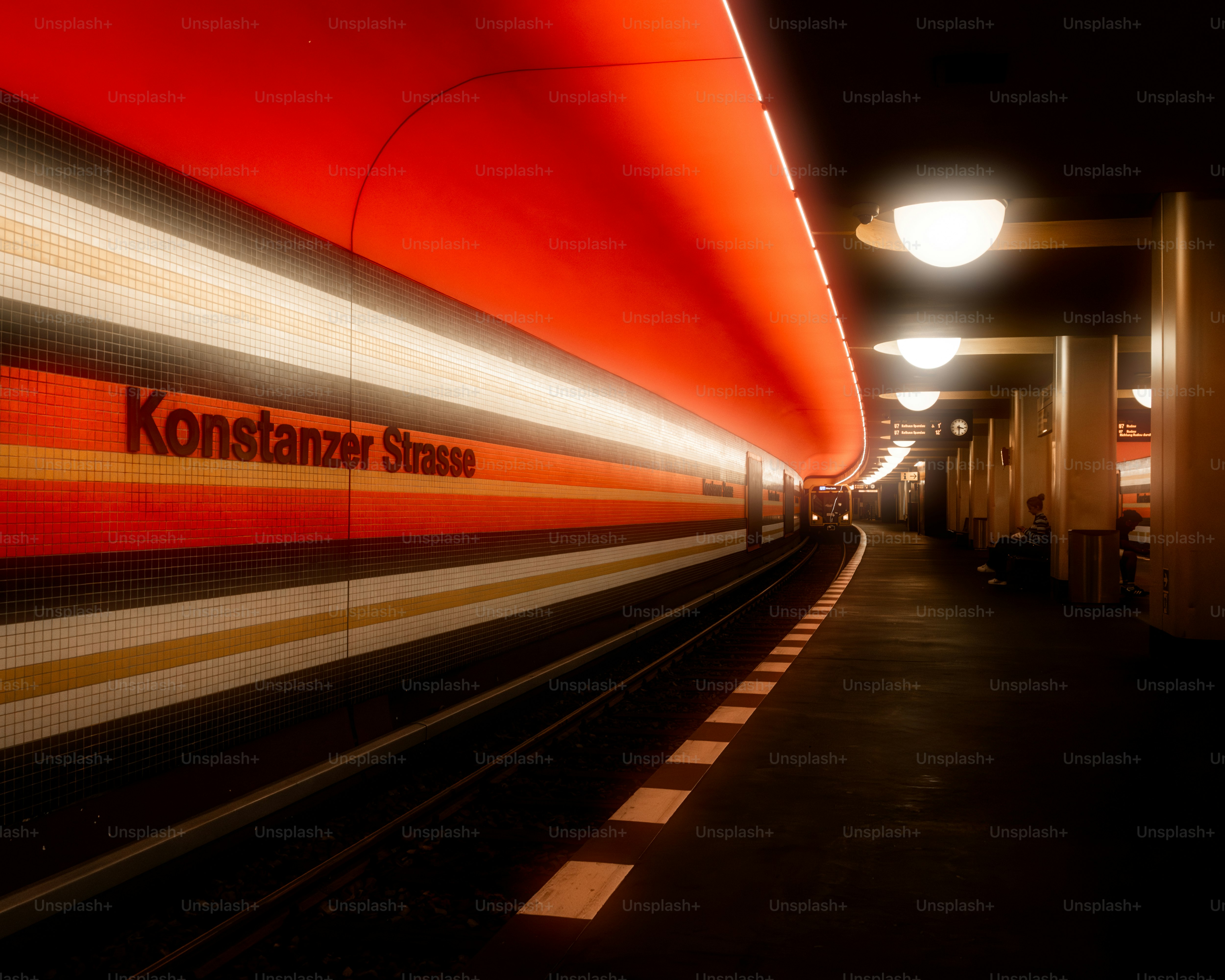 A red and white train traveling down train tracks