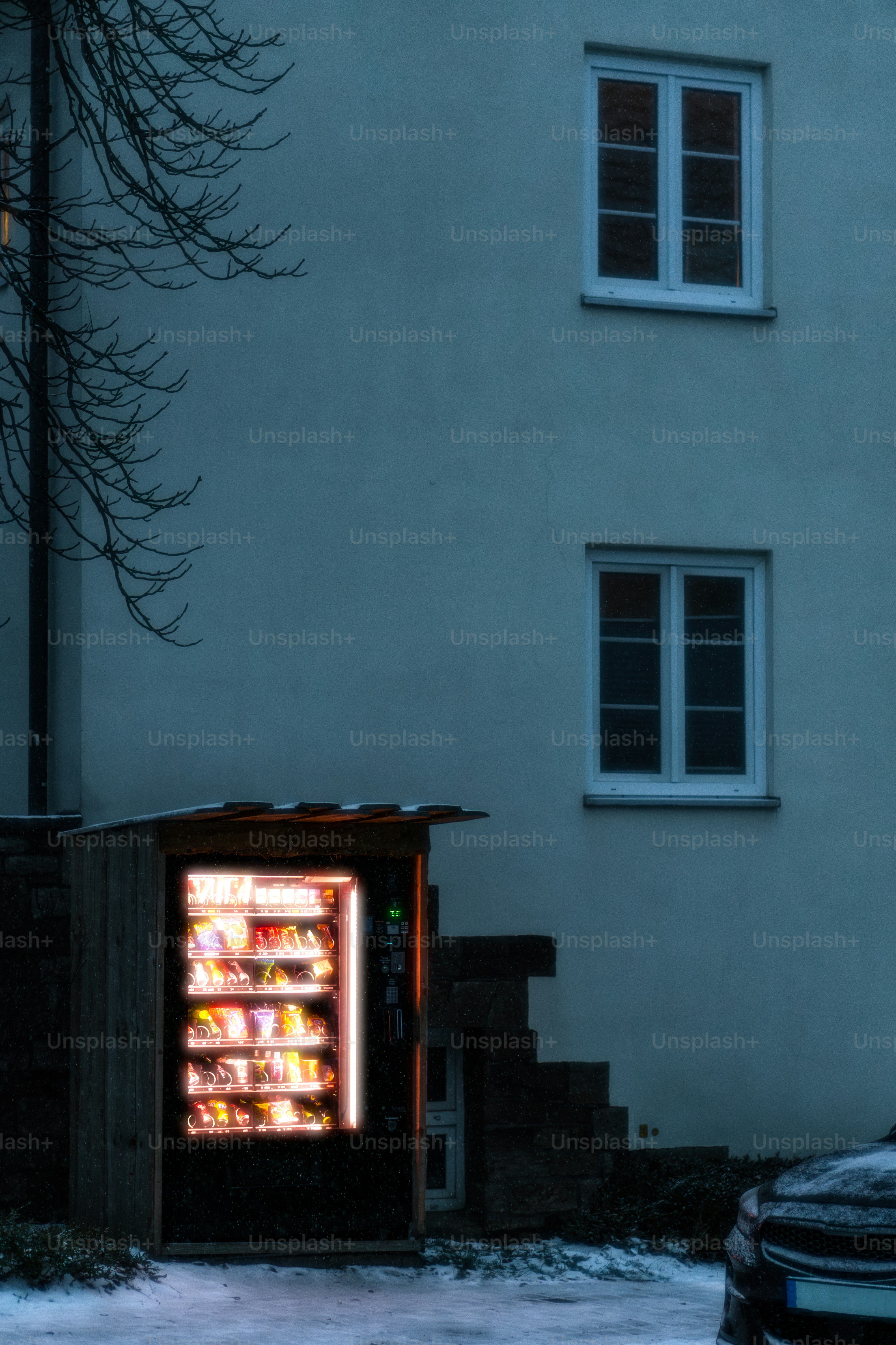 An open refrigerator sitting in front of a building
