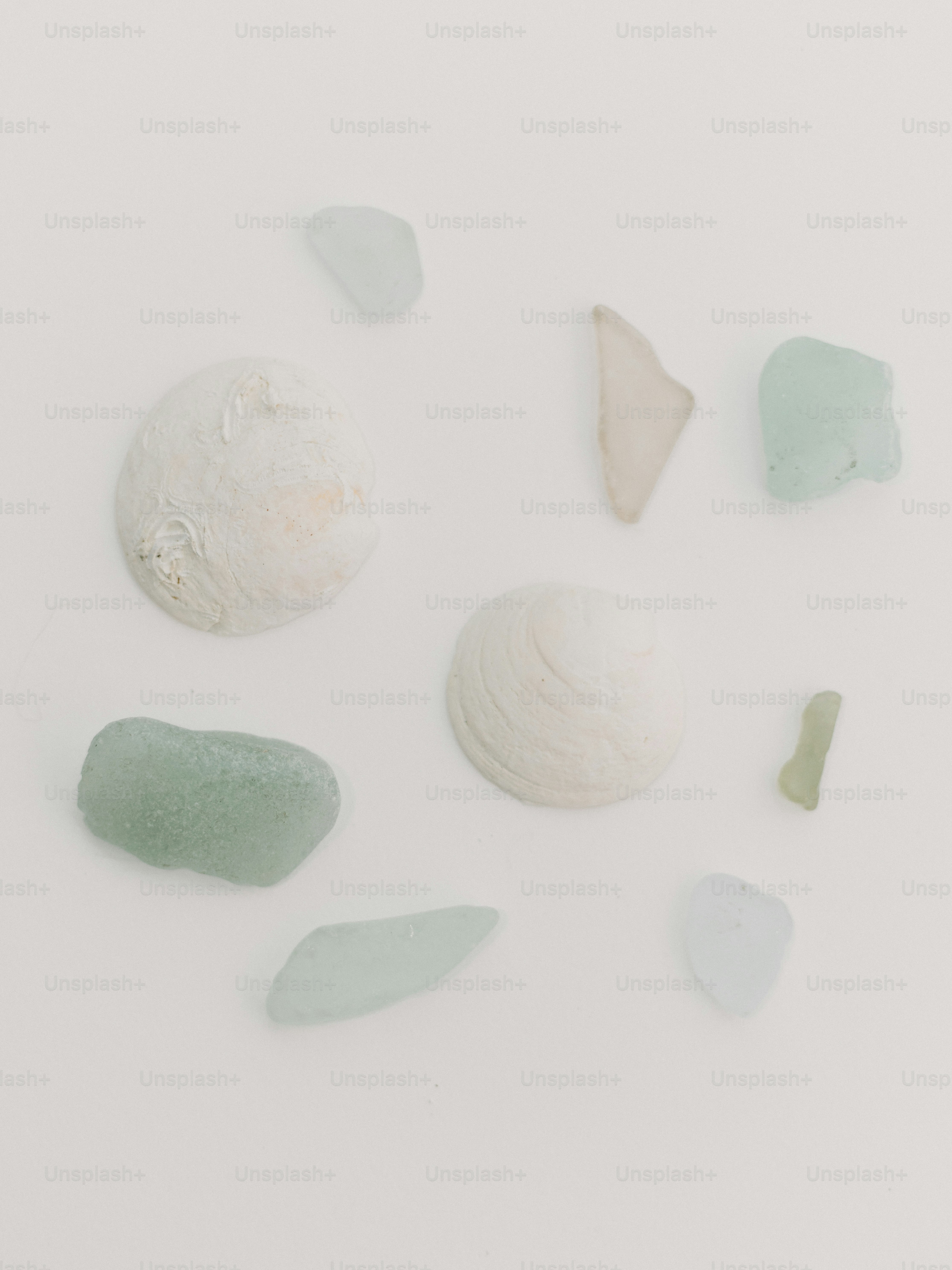 A group of sea glass sitting on top of a white table