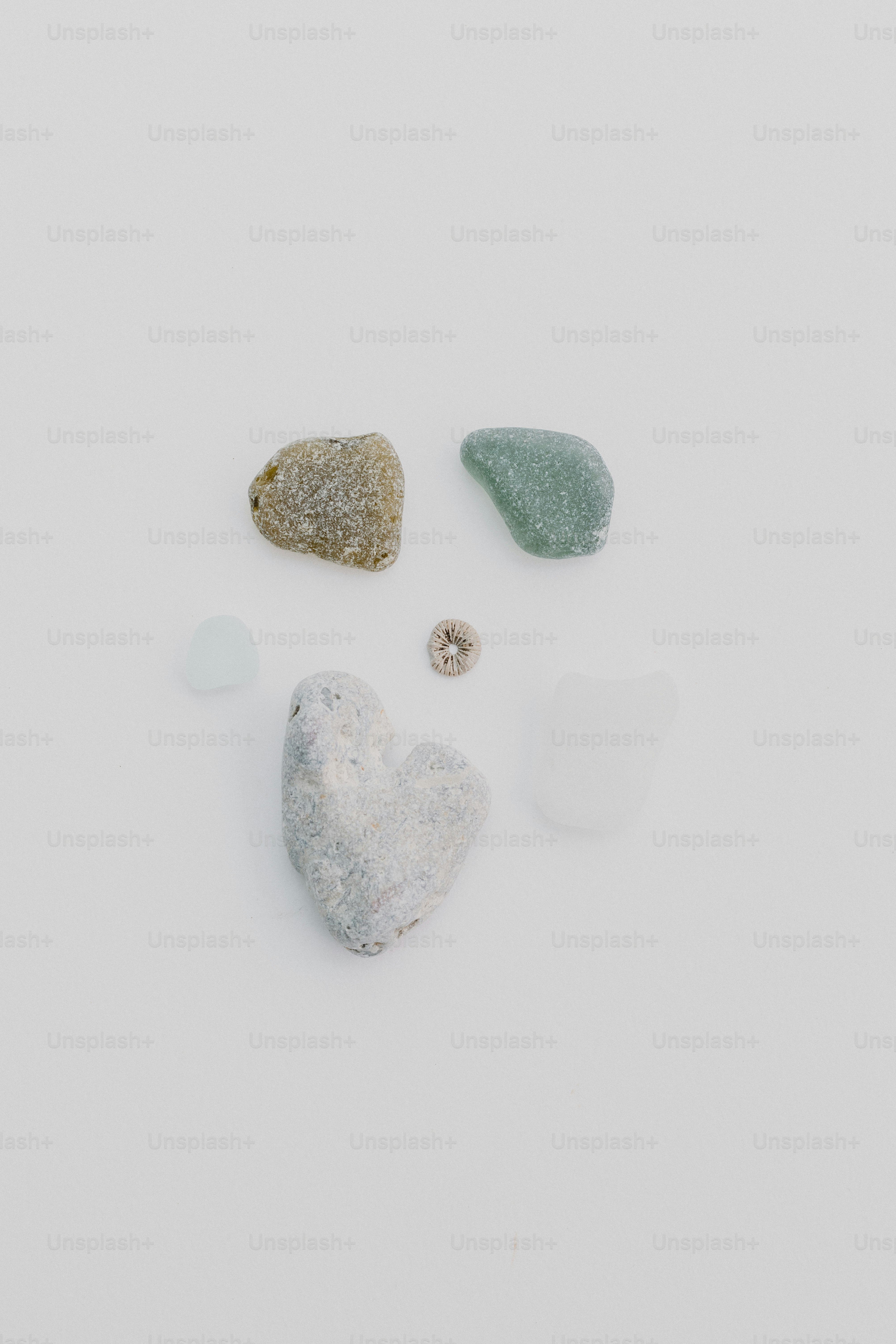 A group of stones sitting on top of a white surface