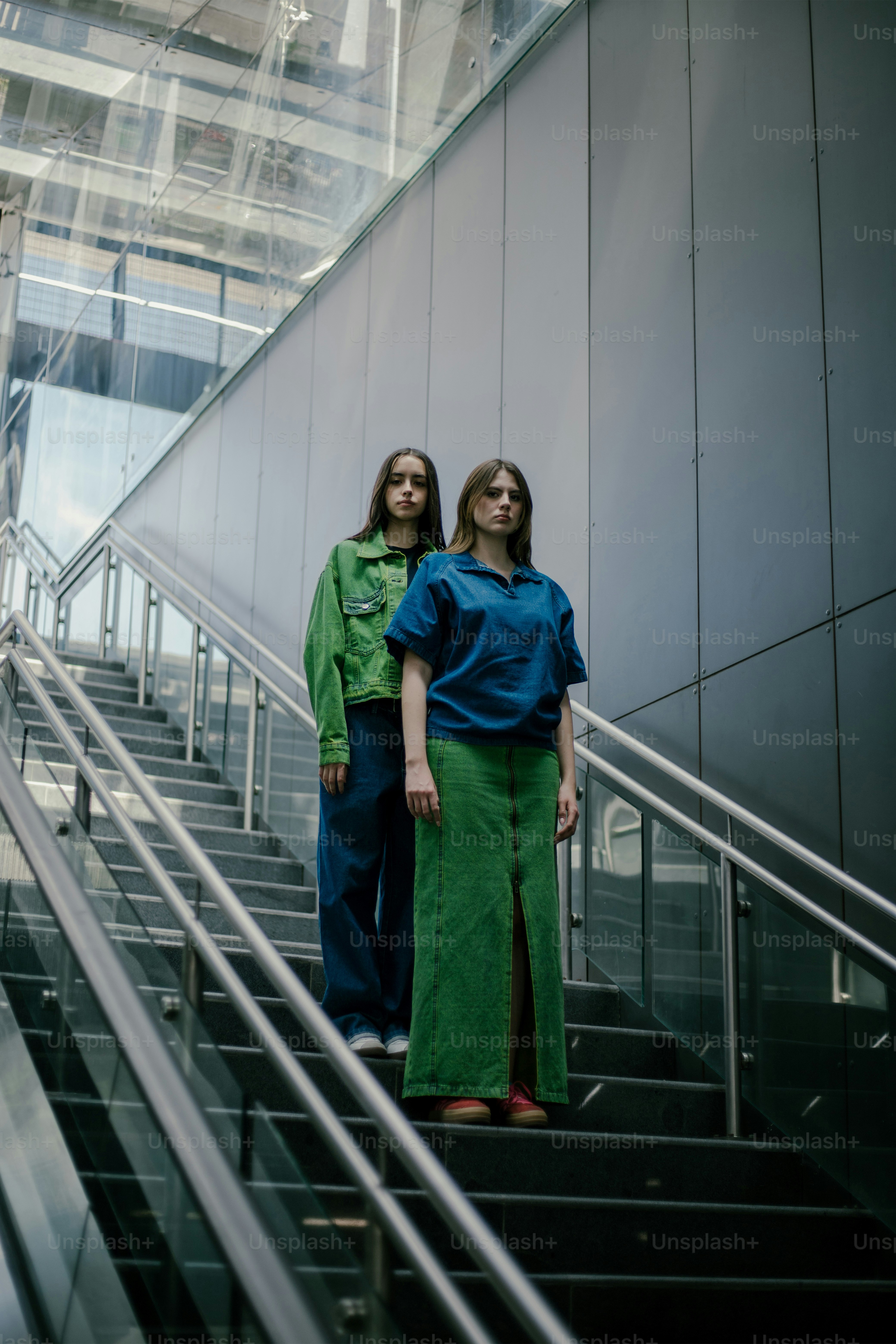 A couple of women standing on top of a set of stairs