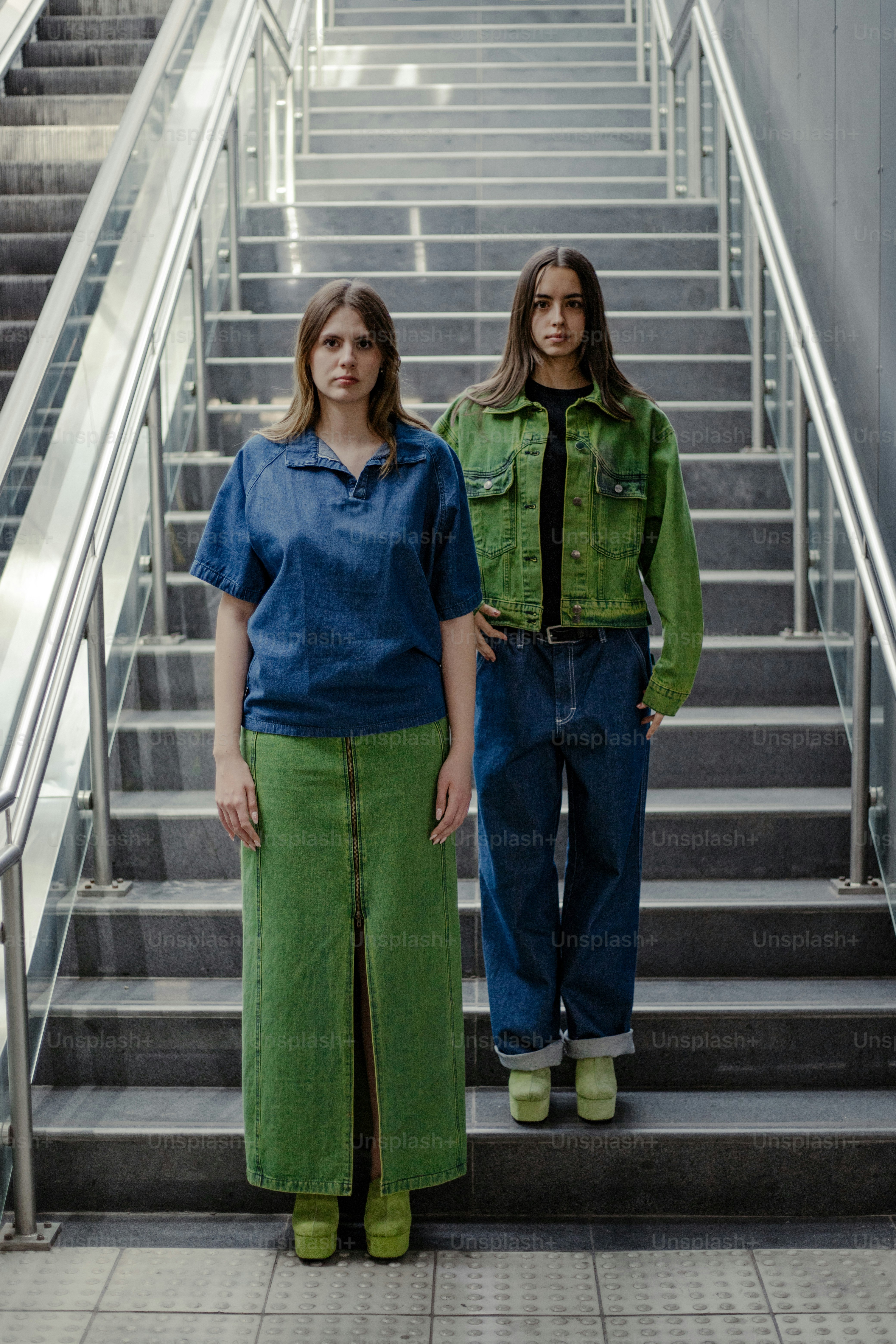 Two women standing in front of a set of stairs