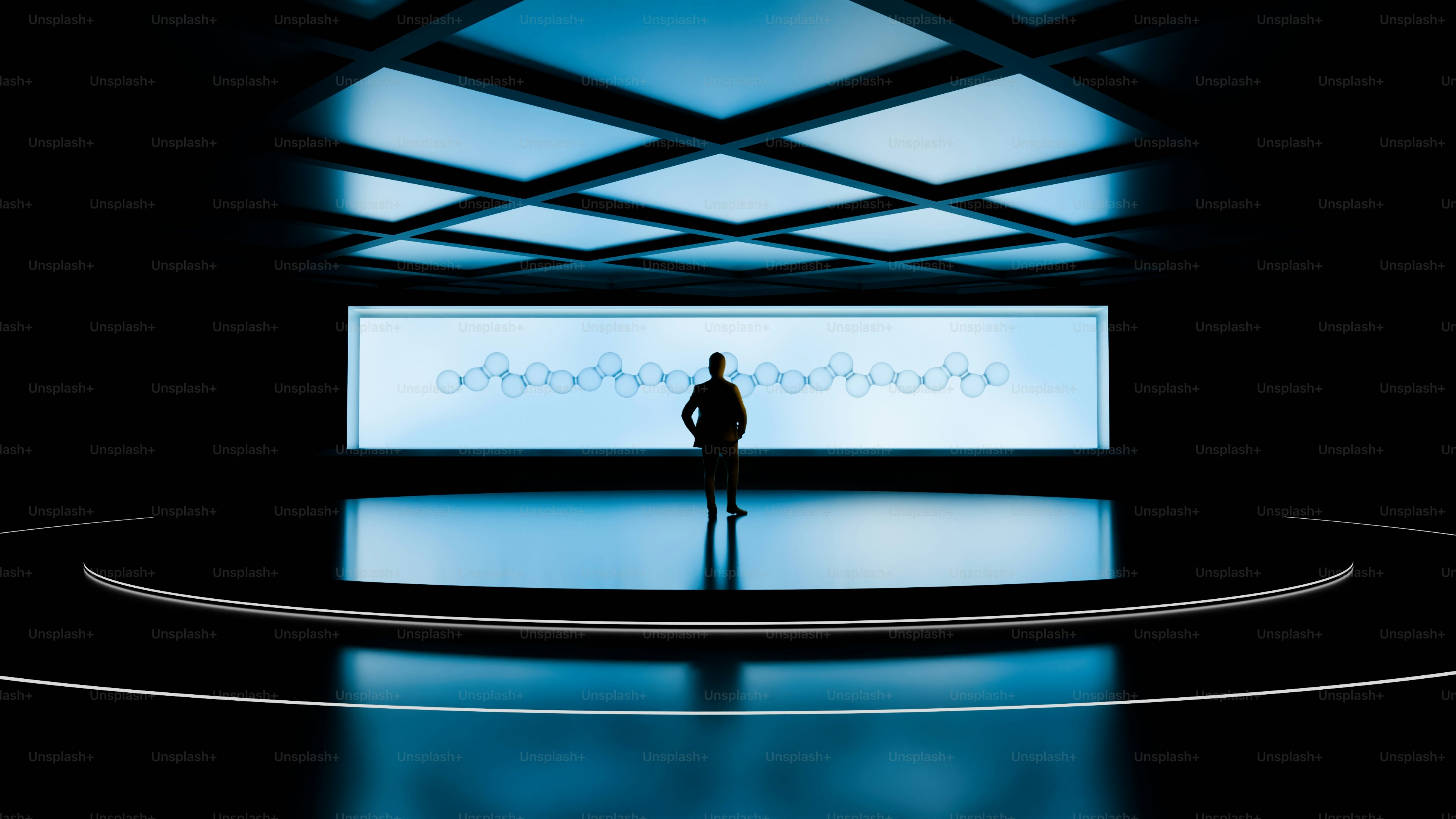 A person standing in front of a large screen