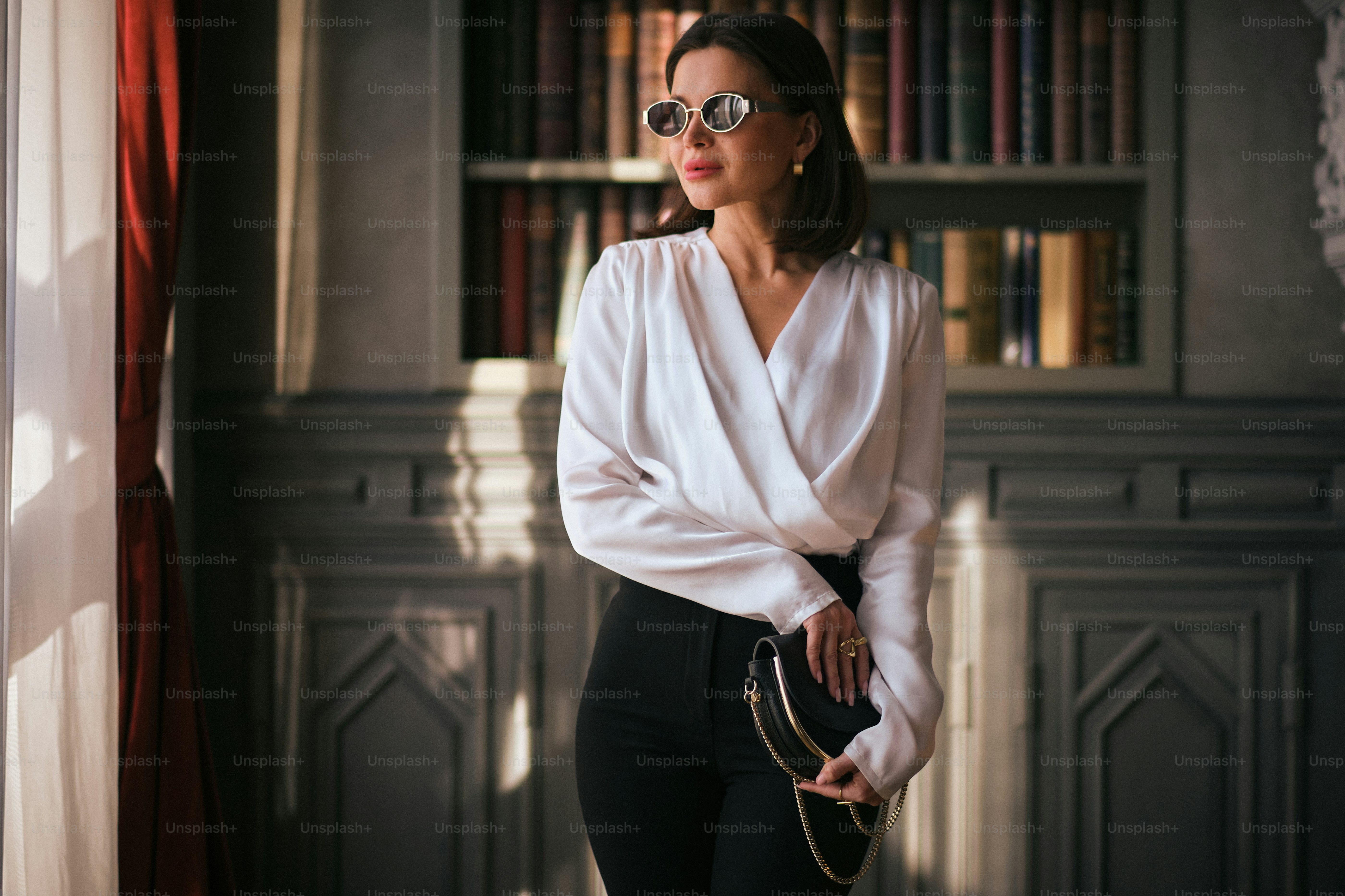 A woman standing in front of a book shelf