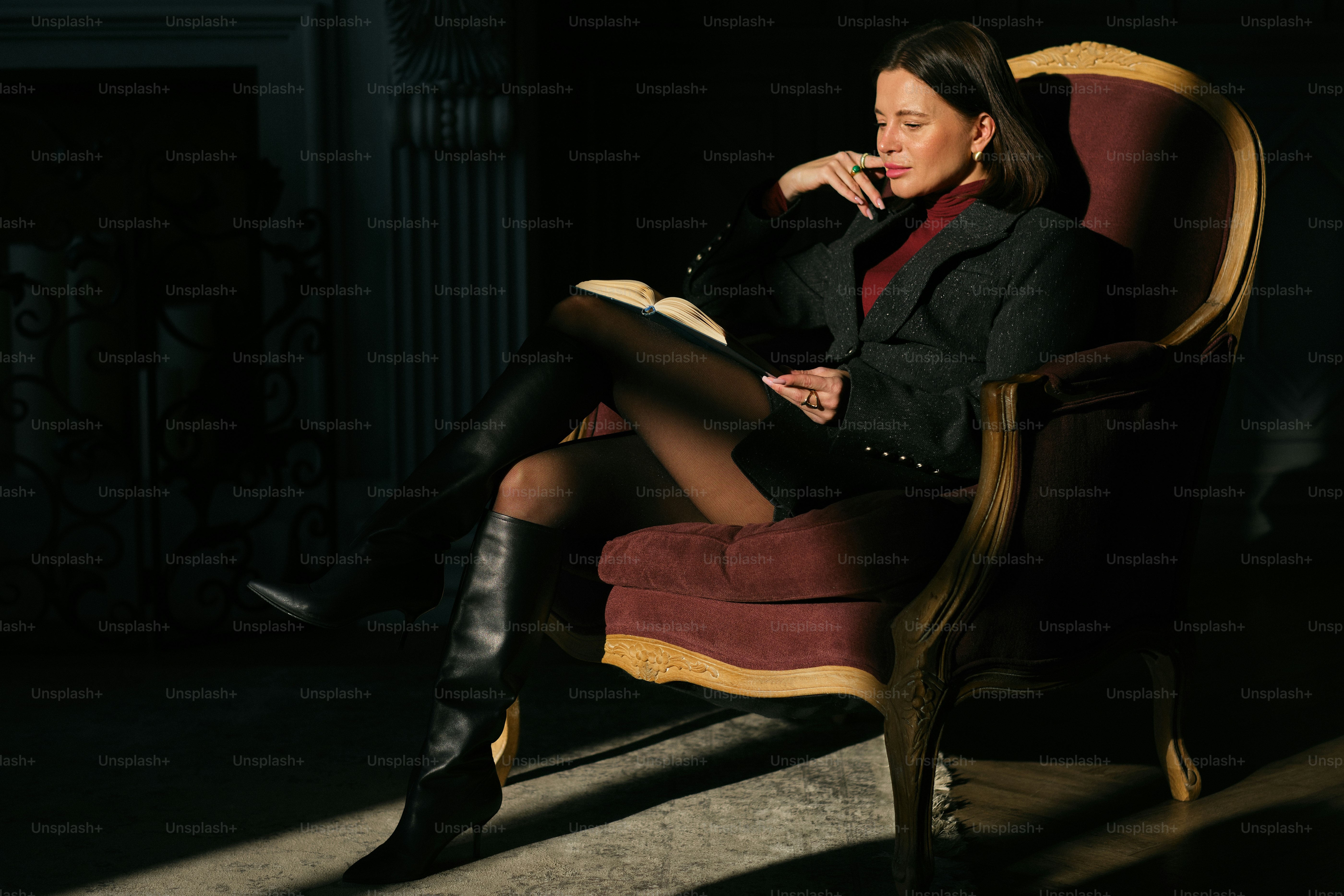 A woman sitting in a chair reading a book