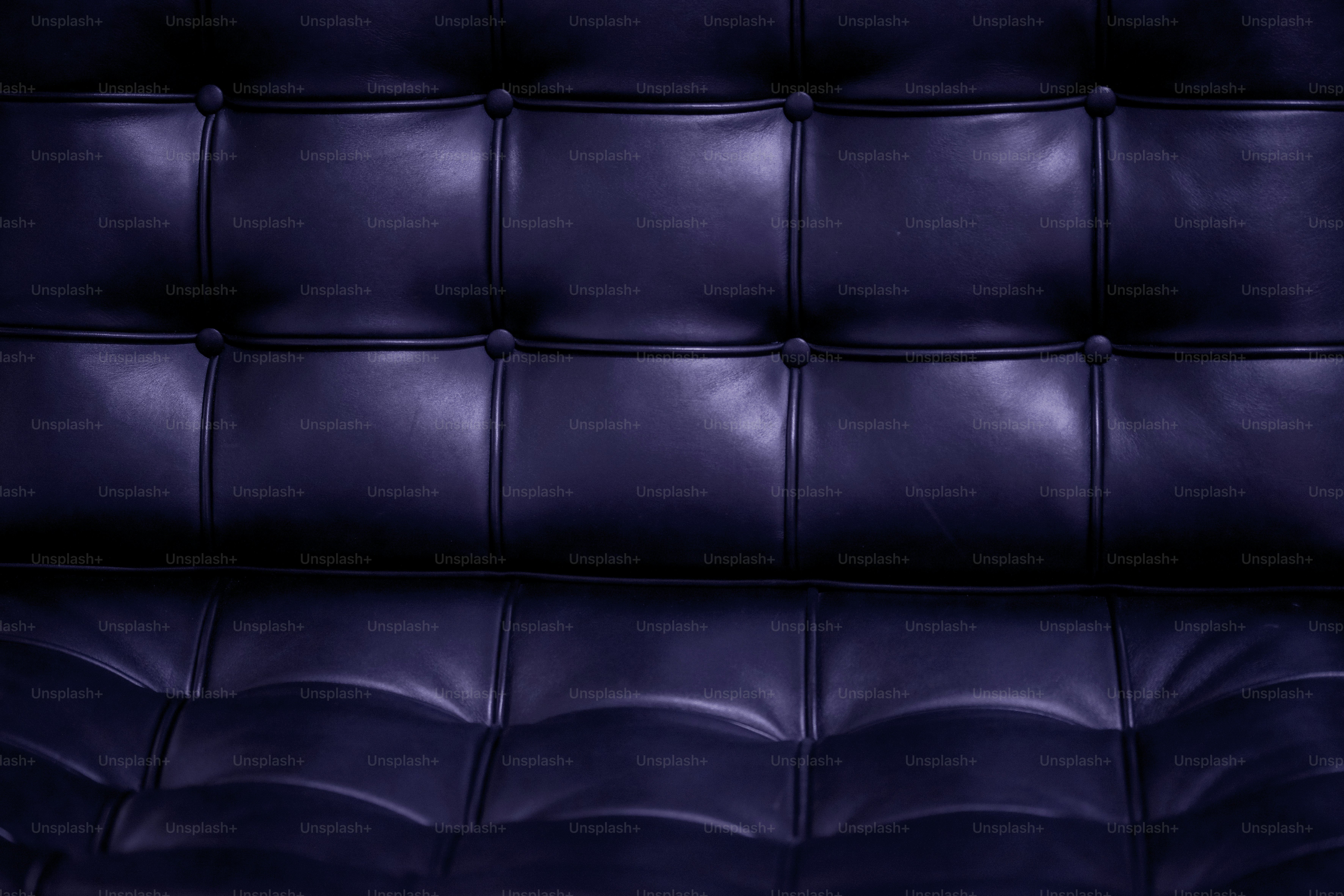 A close up of a purple leather couch