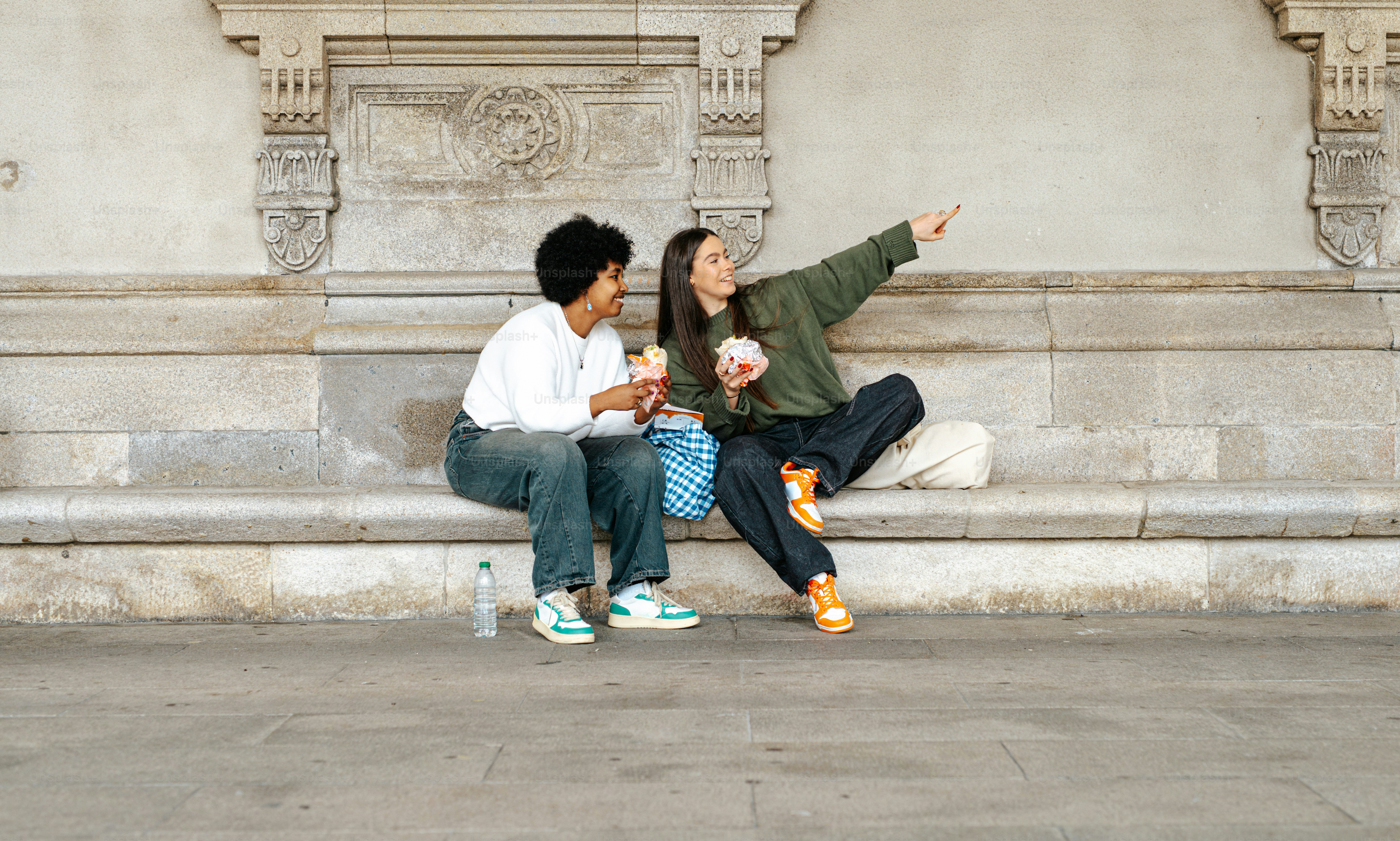 A man and a woman sitting on a bench