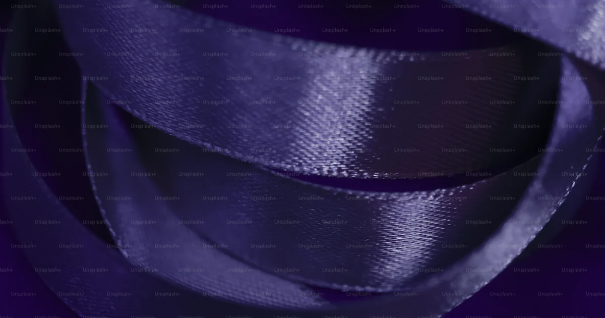 A close up of a purple ribbon on a purple background photo – Fashion ...