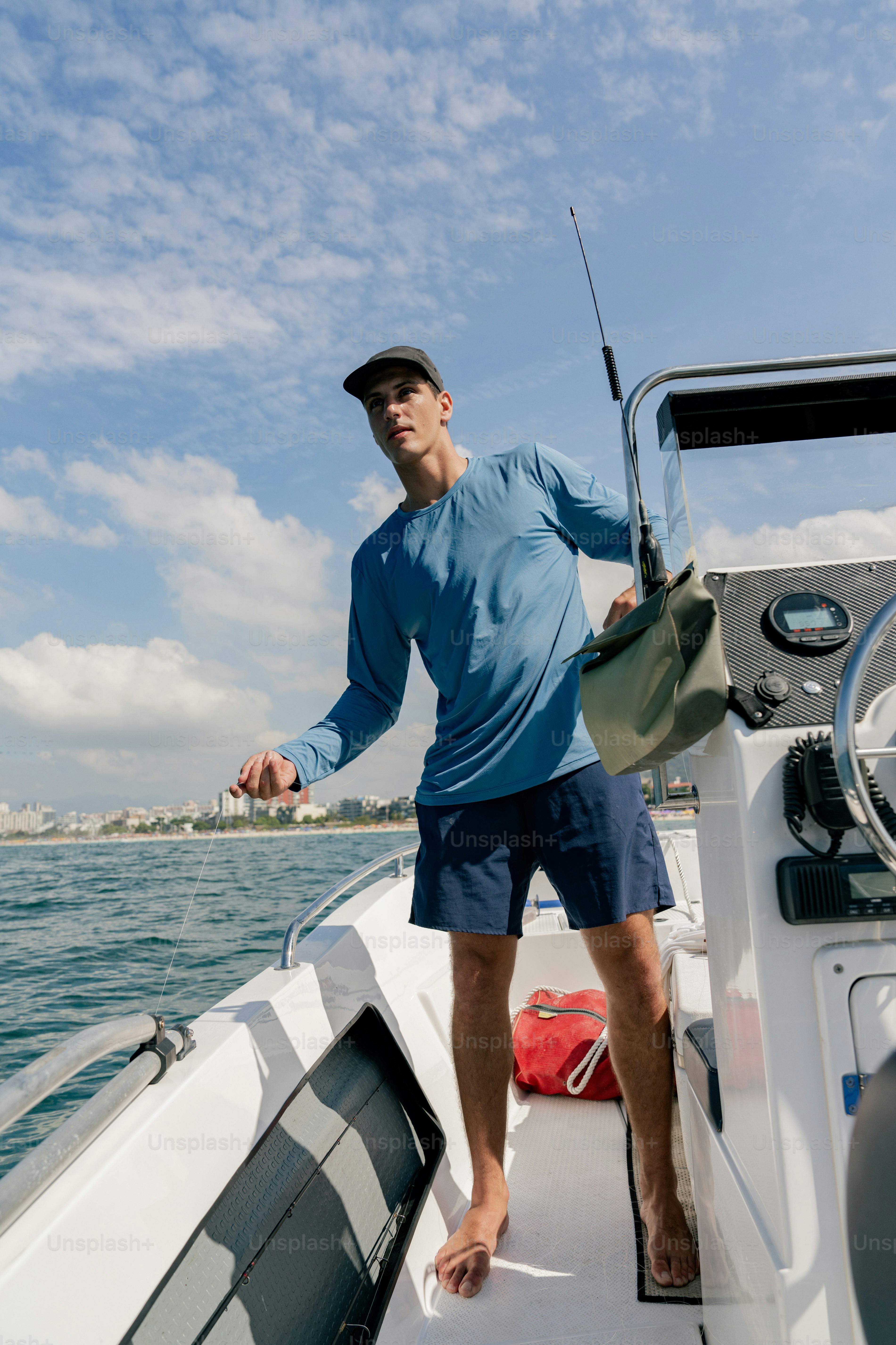 A man standing on the bow of a boat