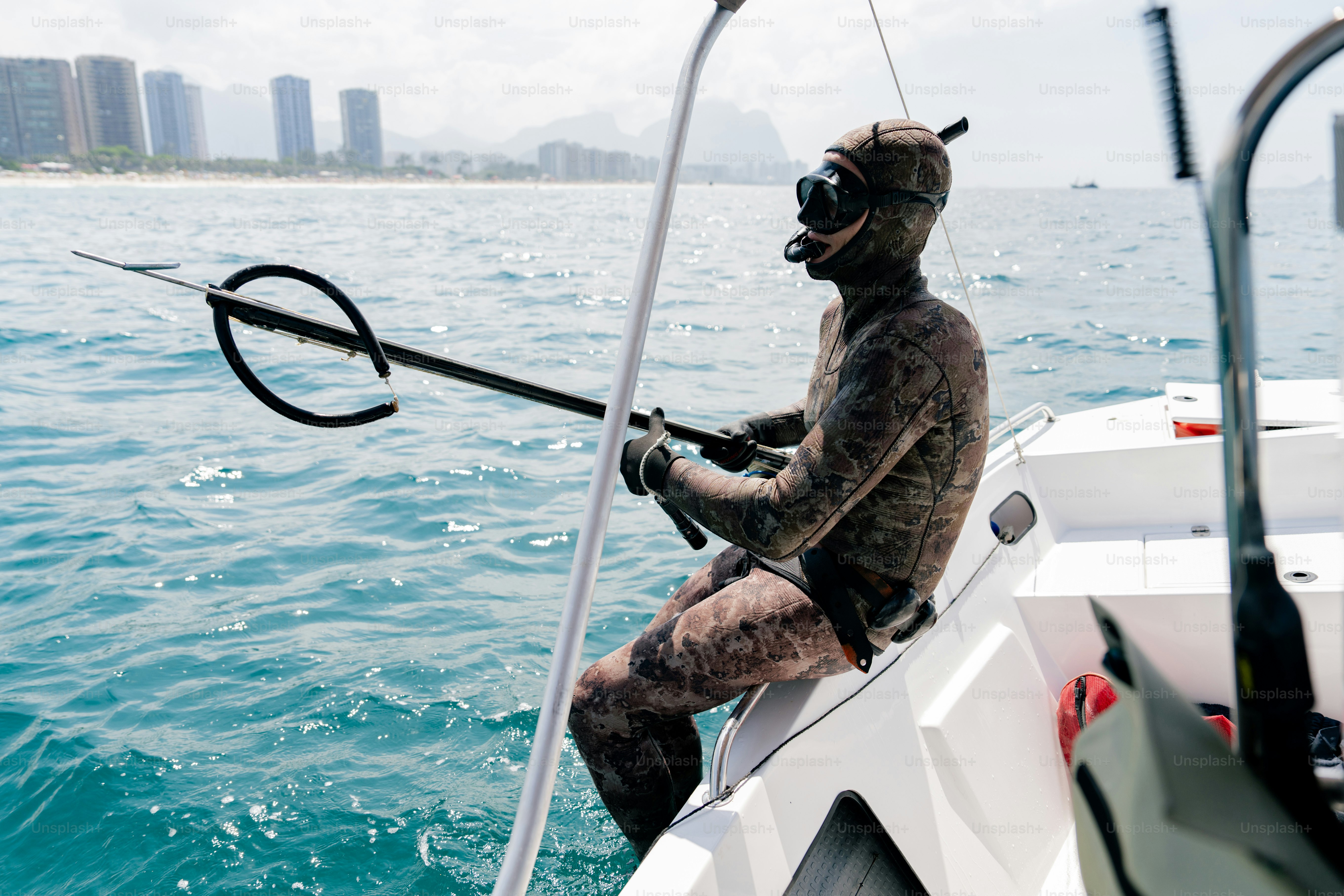 A man sitting on a boat holding a fishing pole