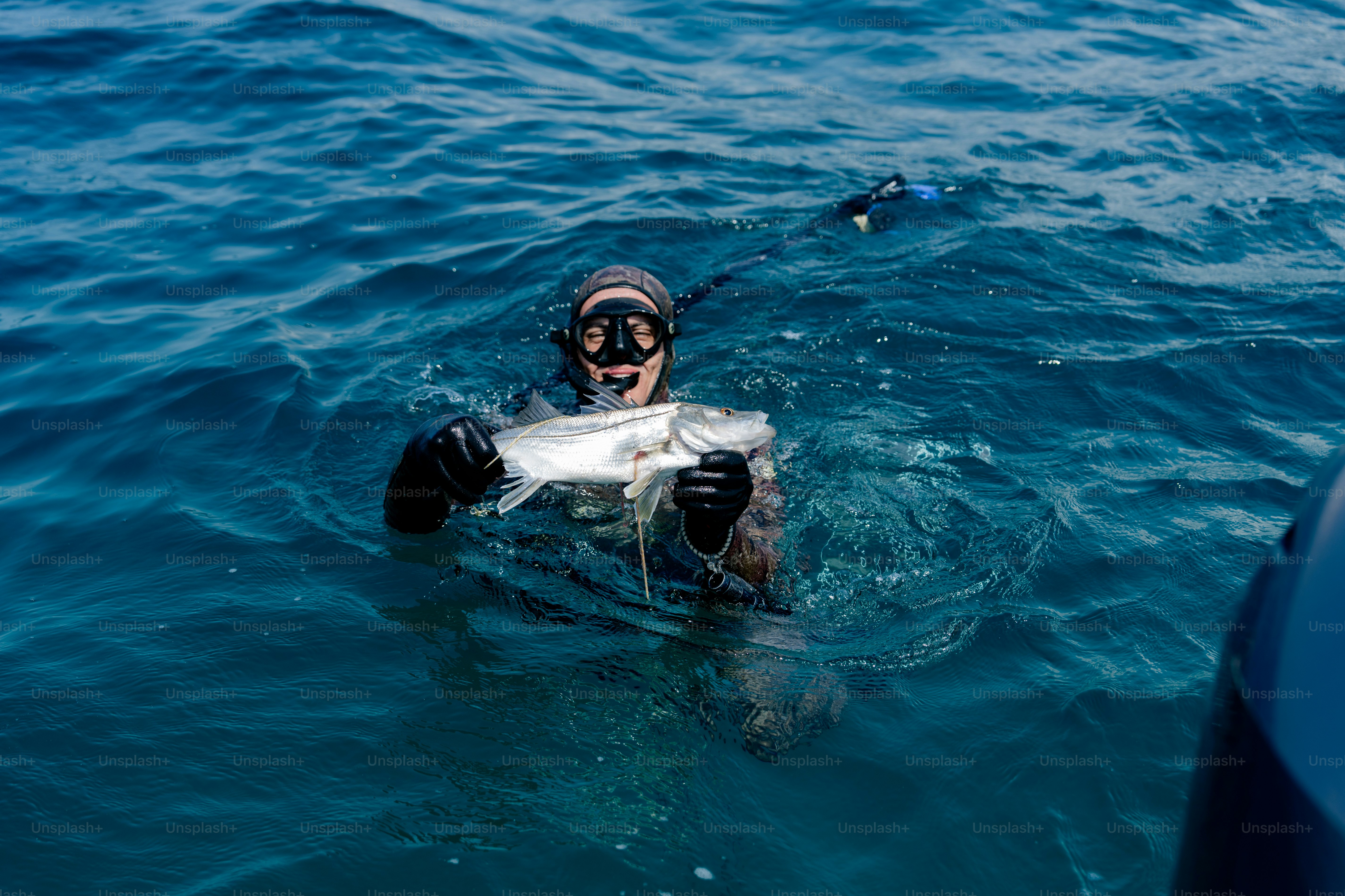 A man in the water with a fish