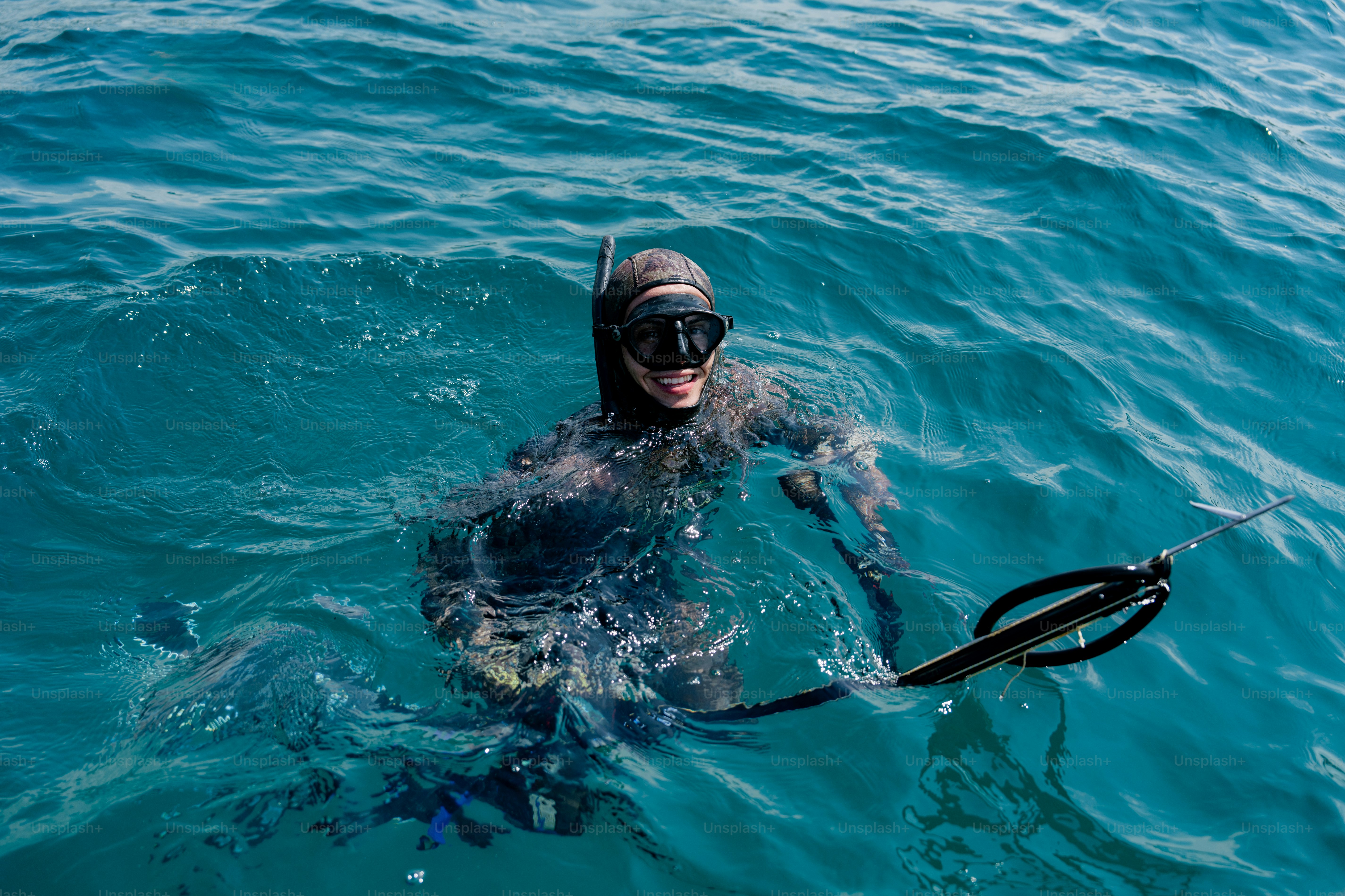 A man swimming in the ocean with a mask on