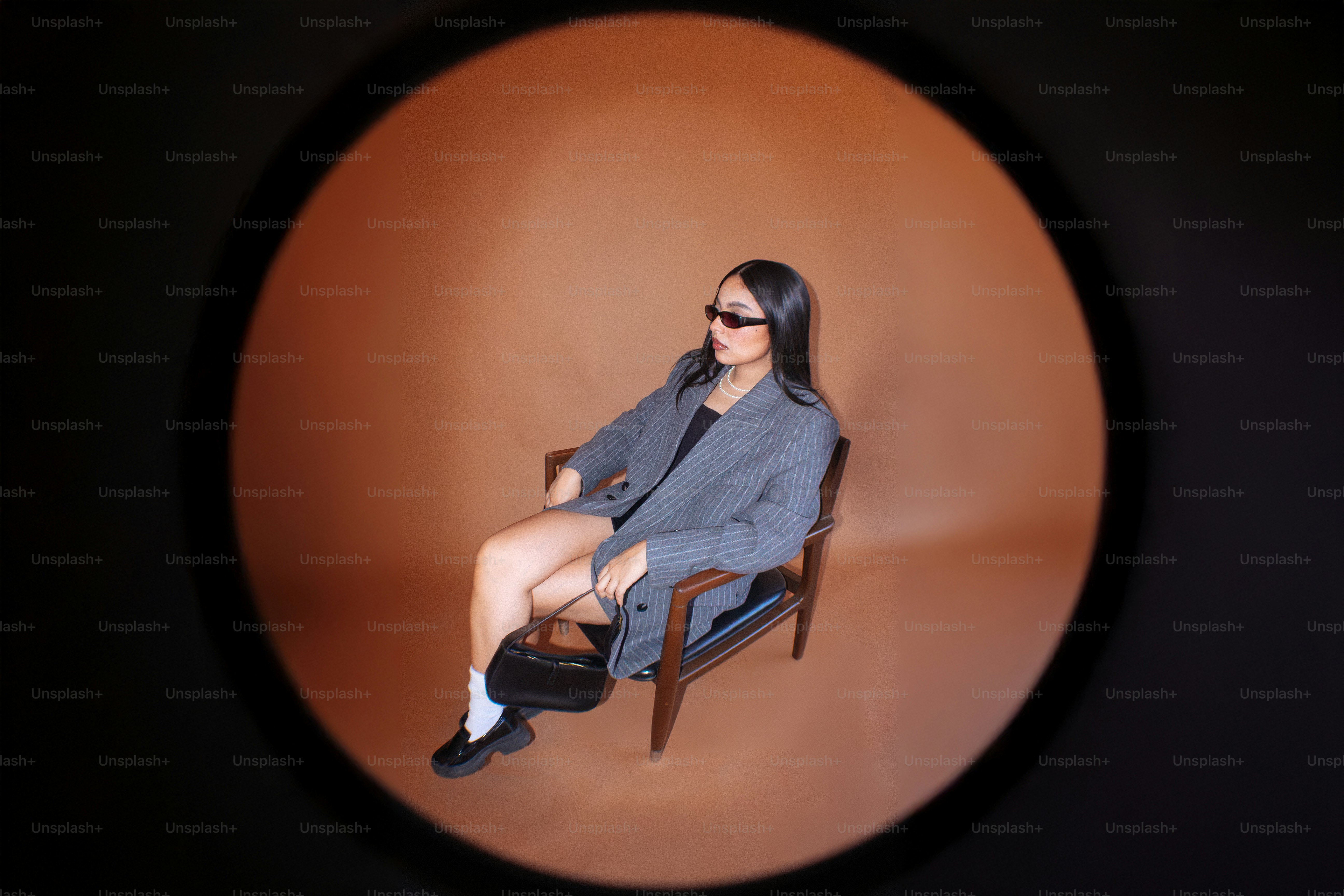 A woman sitting in a chair with her legs crossed
