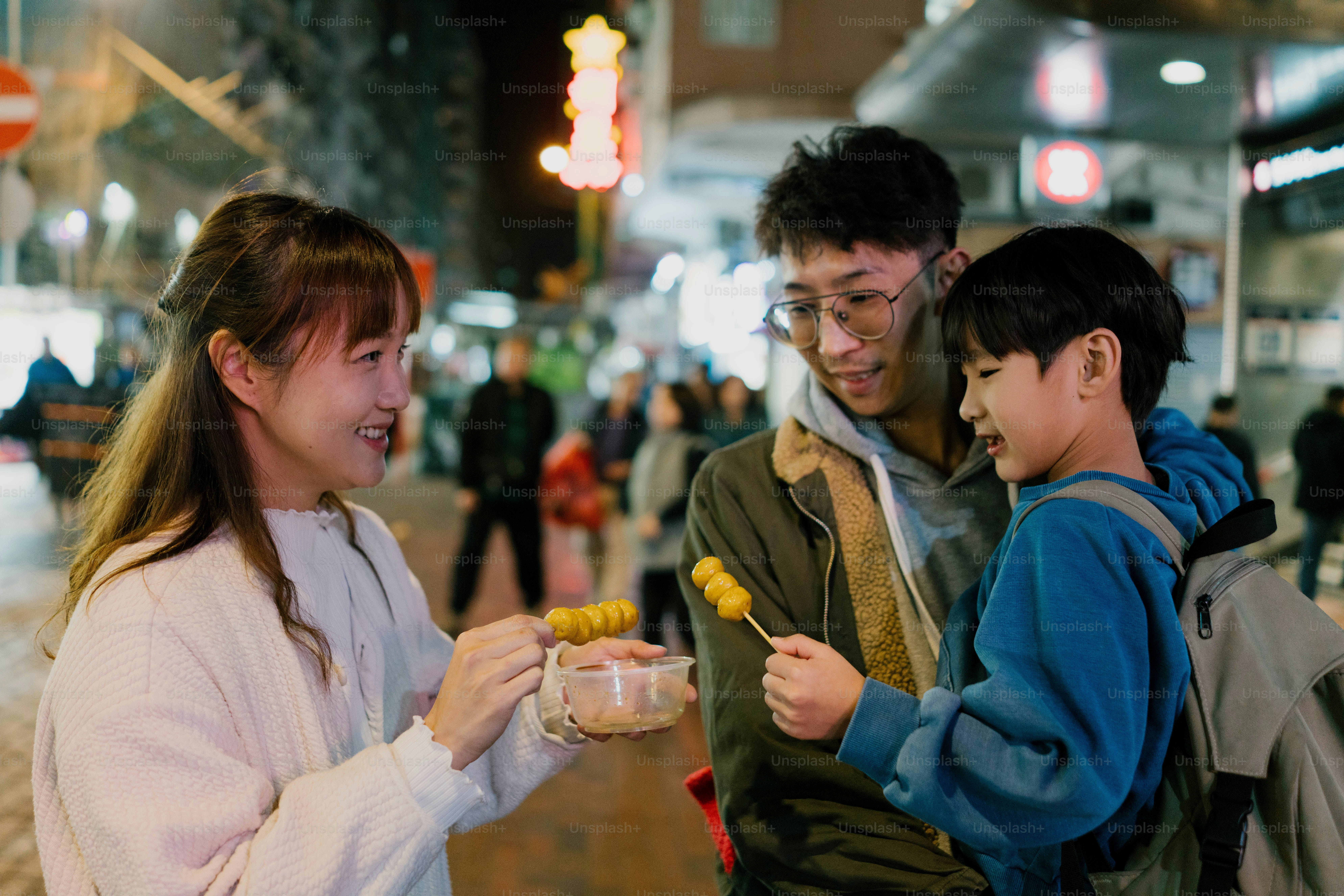 A group of people standing next to each other on a street