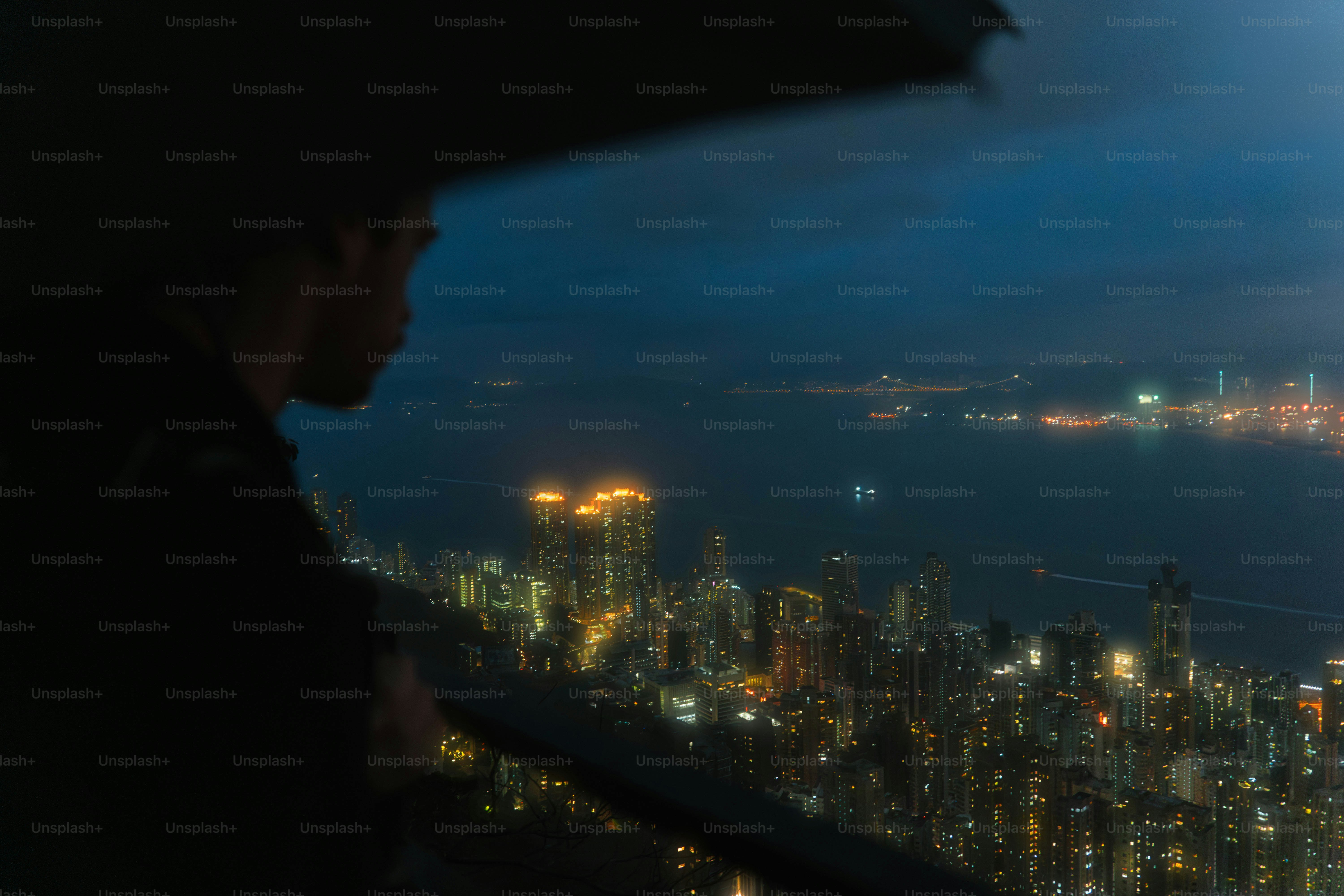 A view of a city at night from the top of a building photo – City Image ...