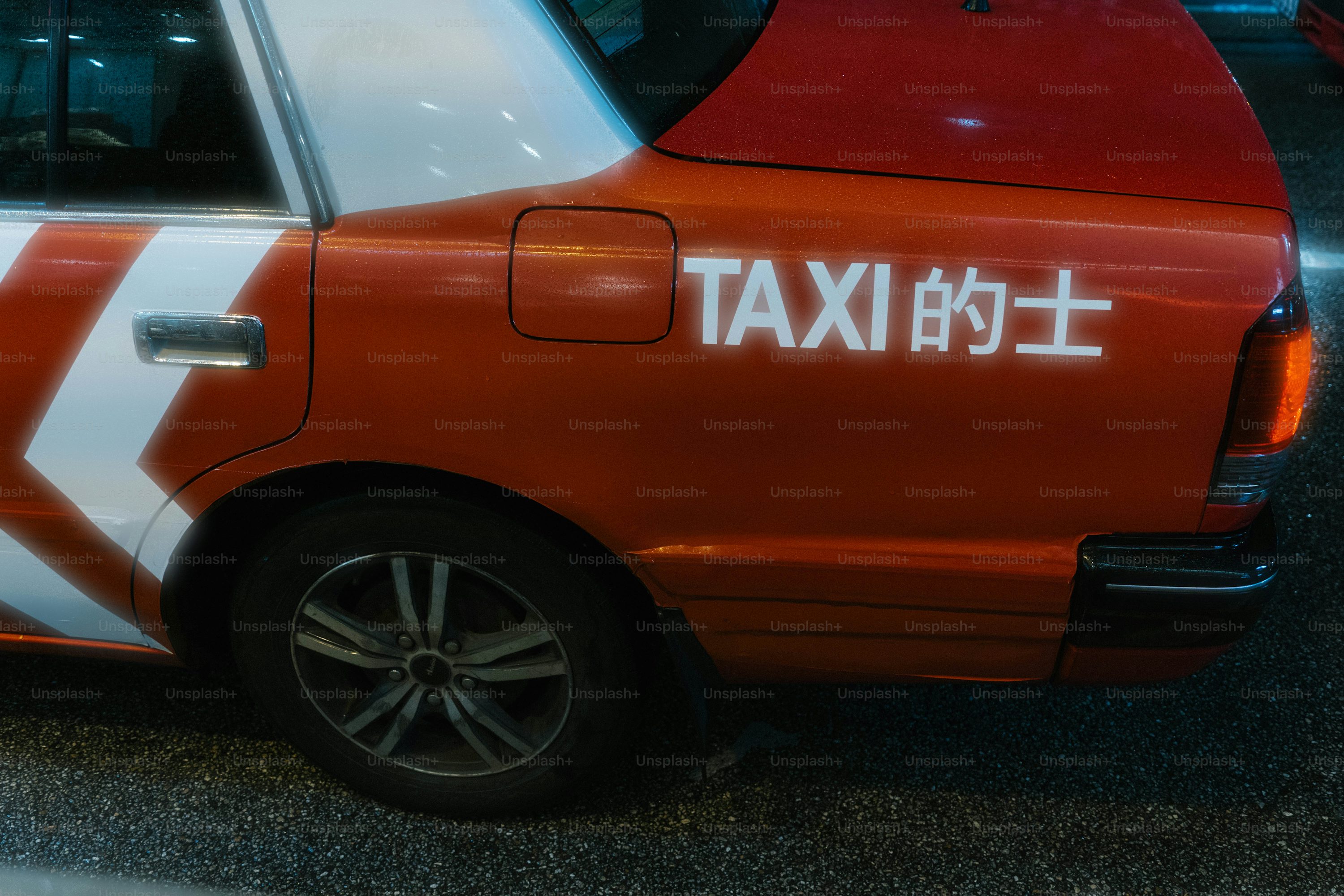 A taxi cab with a japanese writing on the side of it