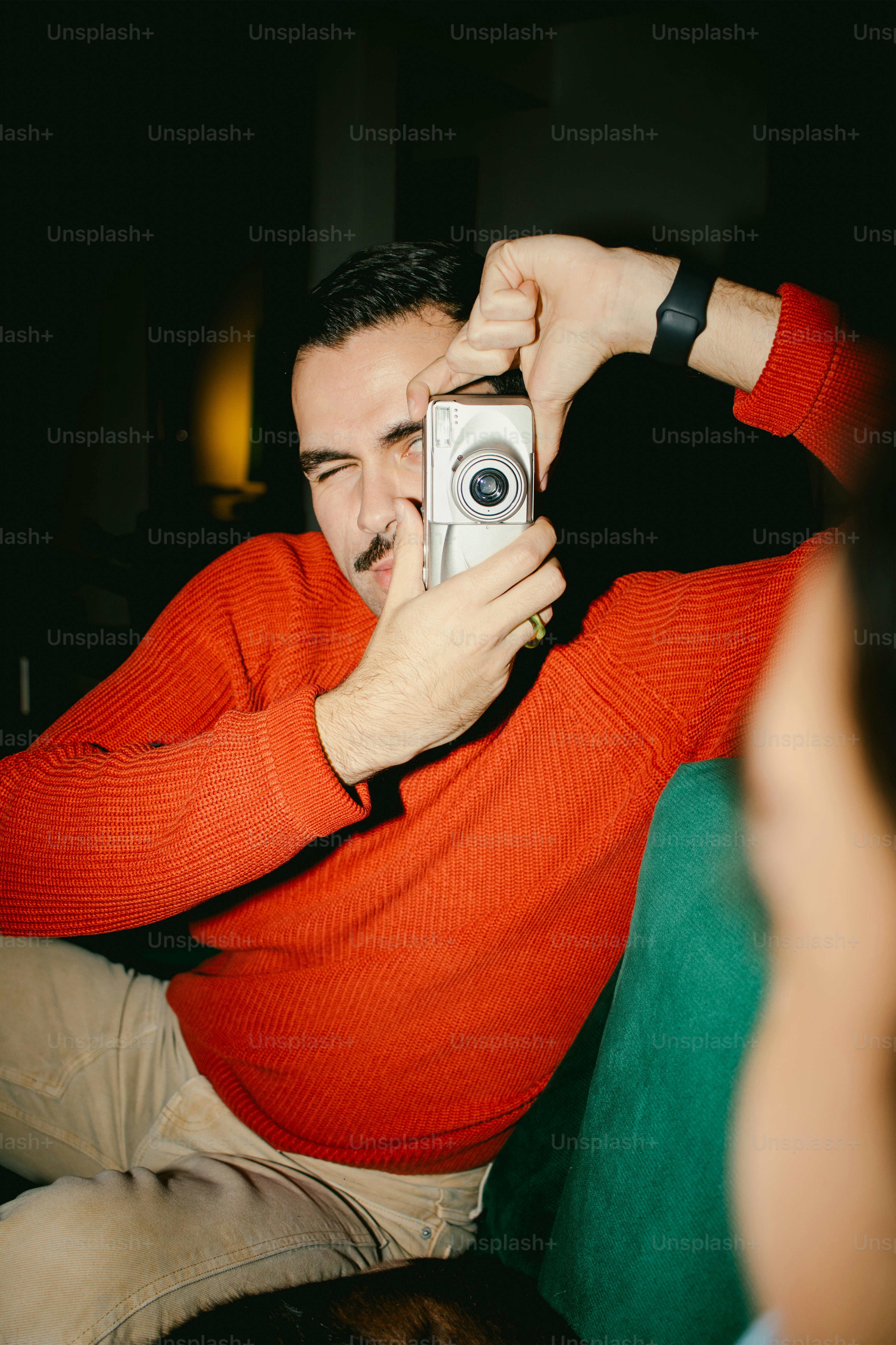 A man takes a photo with a camera.