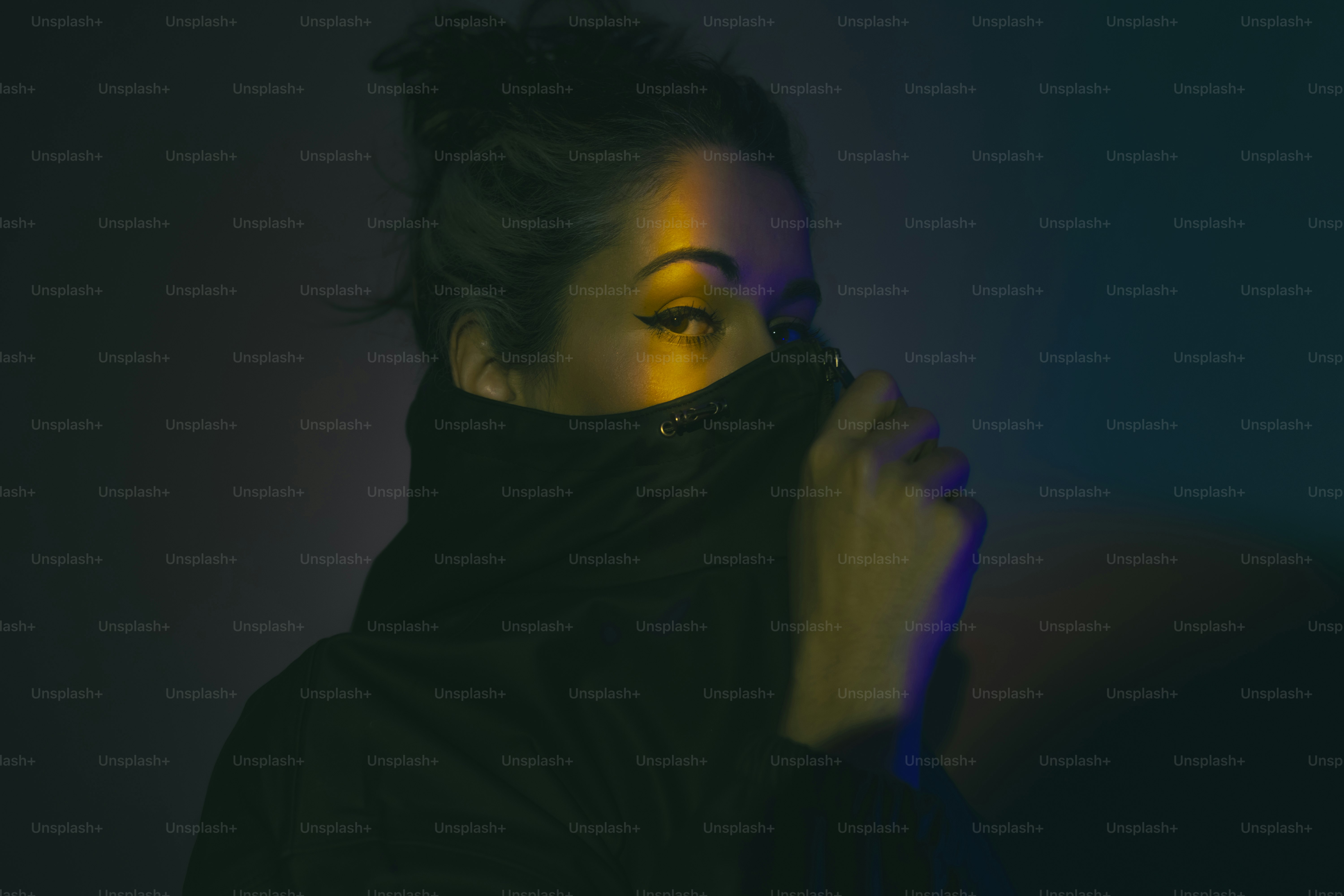 Woman with turtleneck hides her face with clothing.