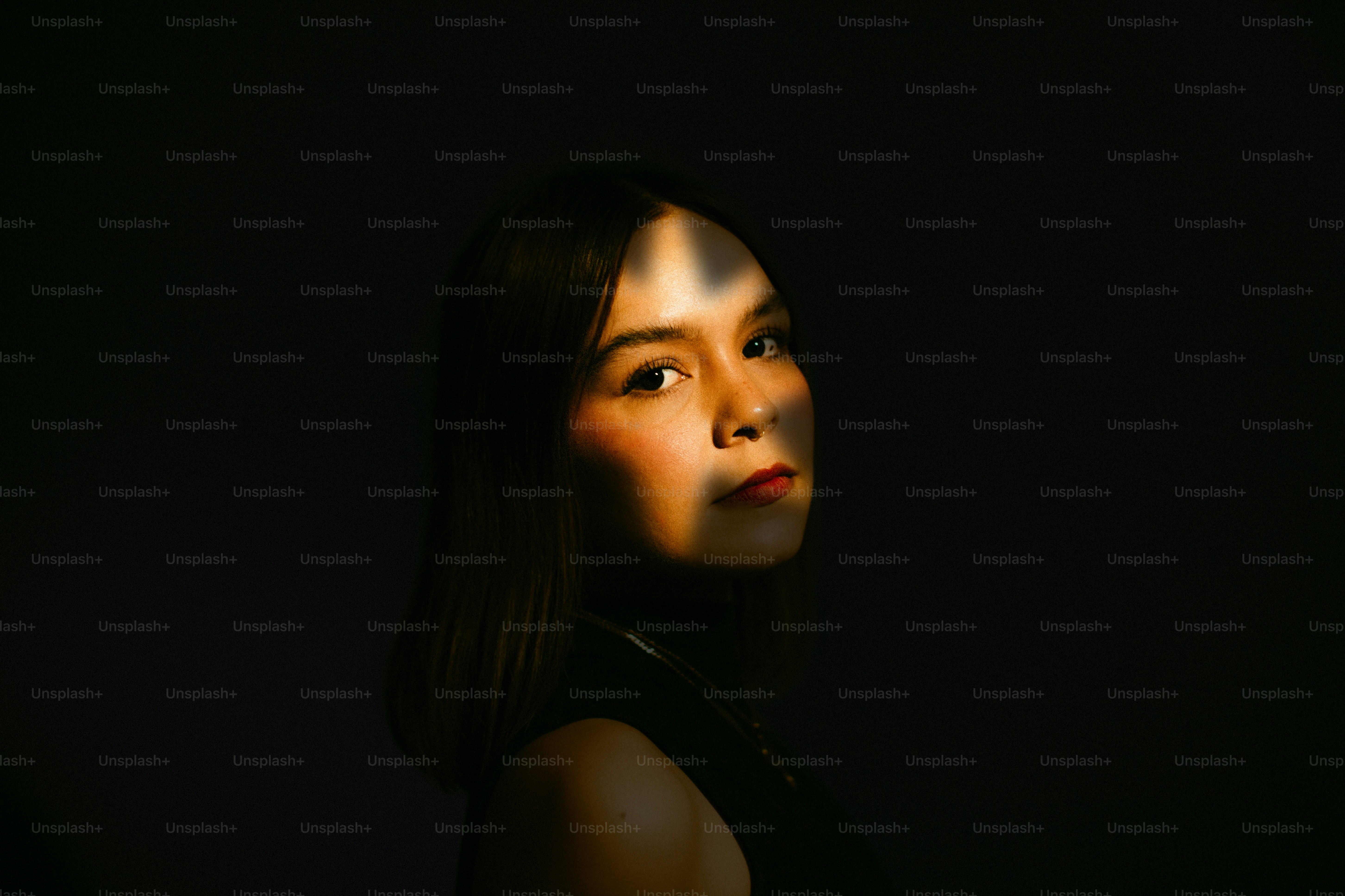 Una donna posa in una luce e un'ombra sorprendenti.