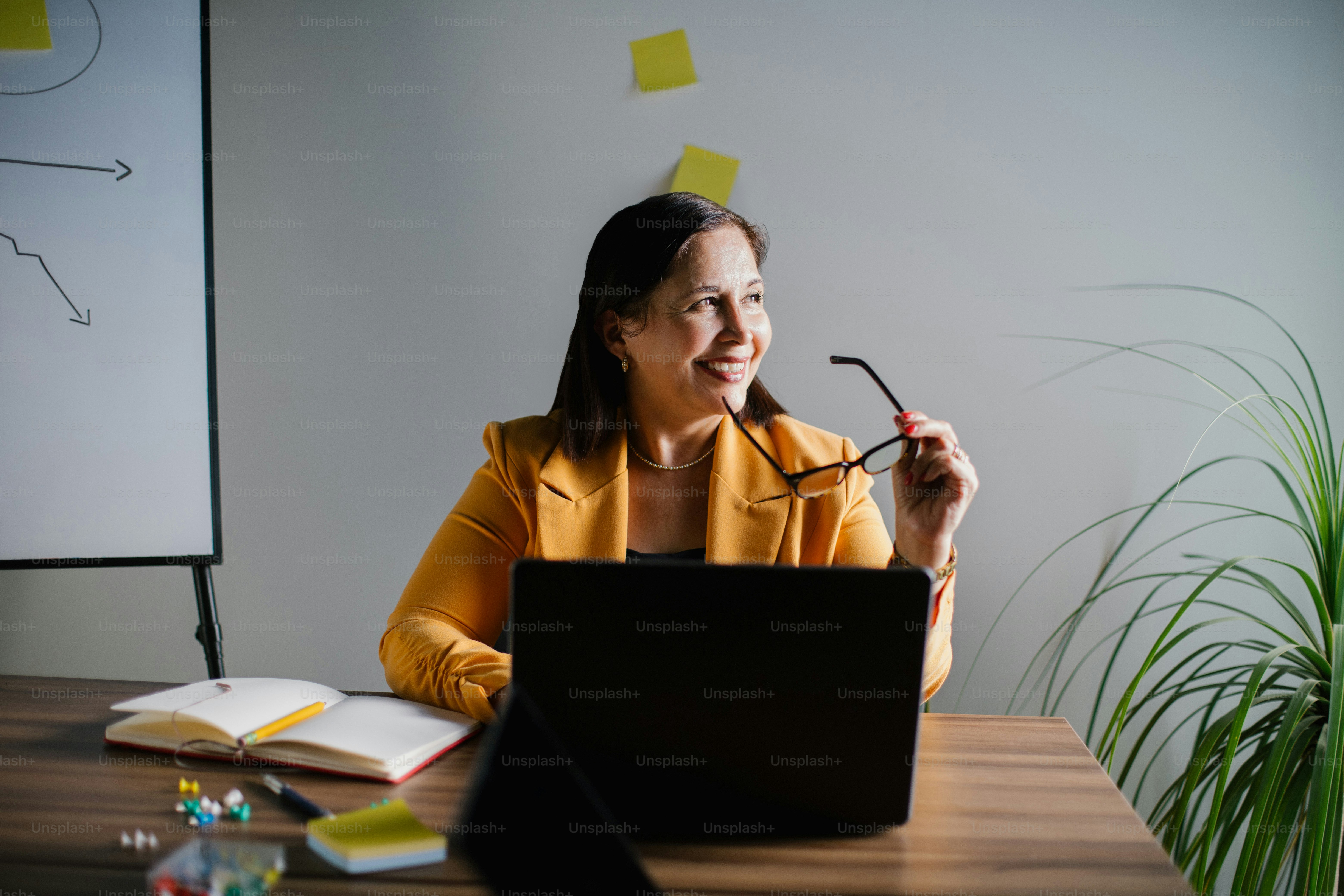 A happy businesswoman is working on her computer.