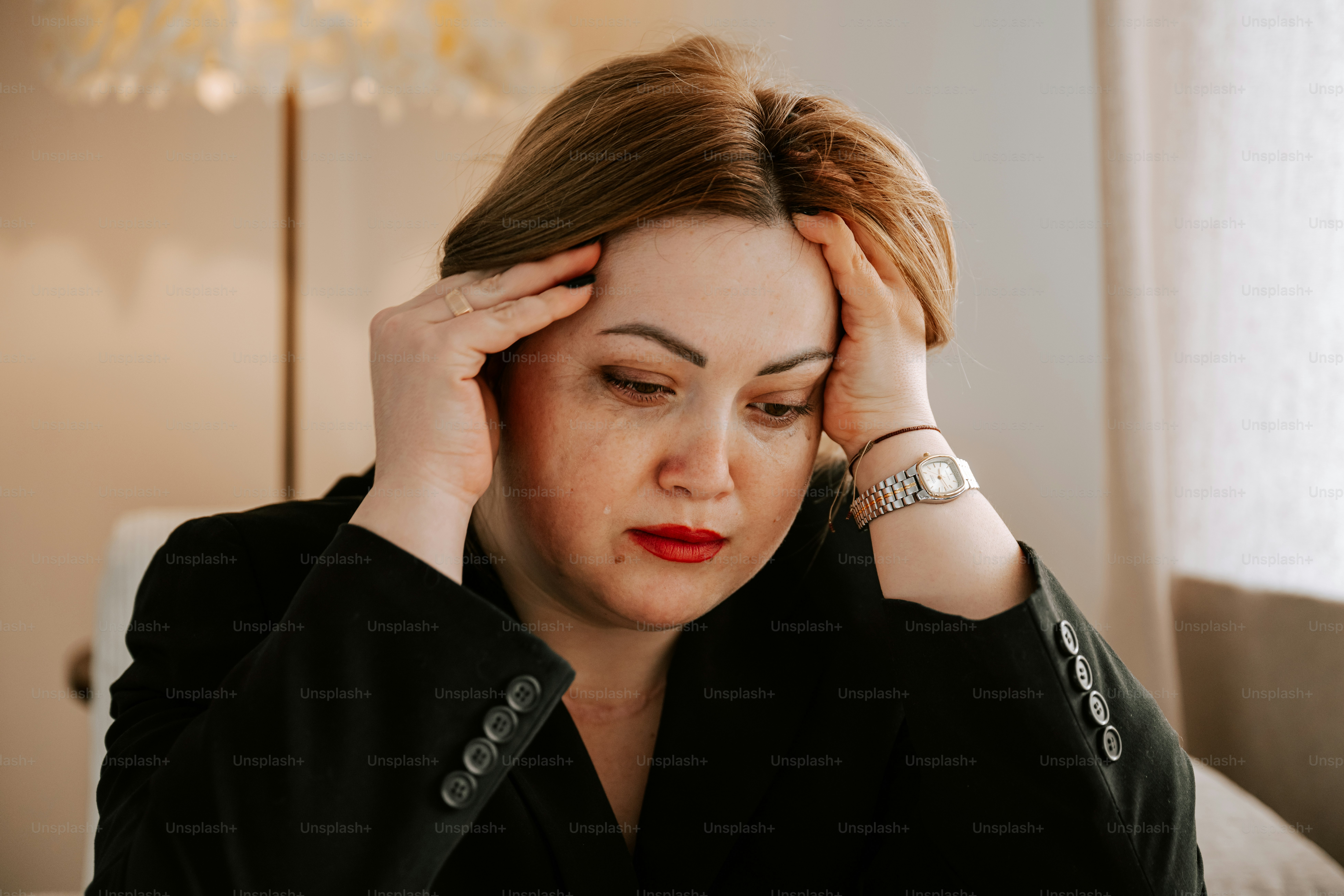 A woman is experiencing stress or a headache.