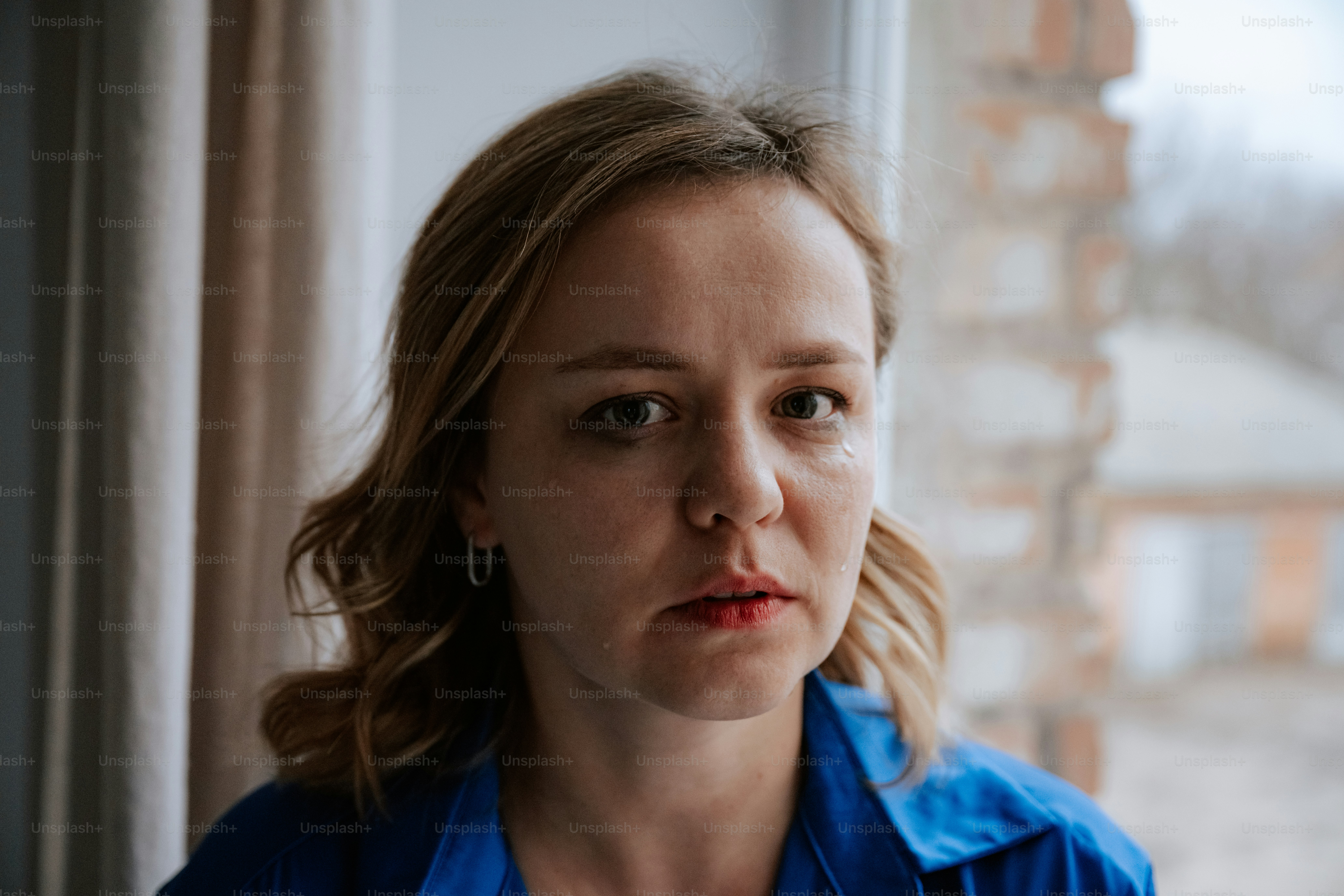 Woman in front of a window.