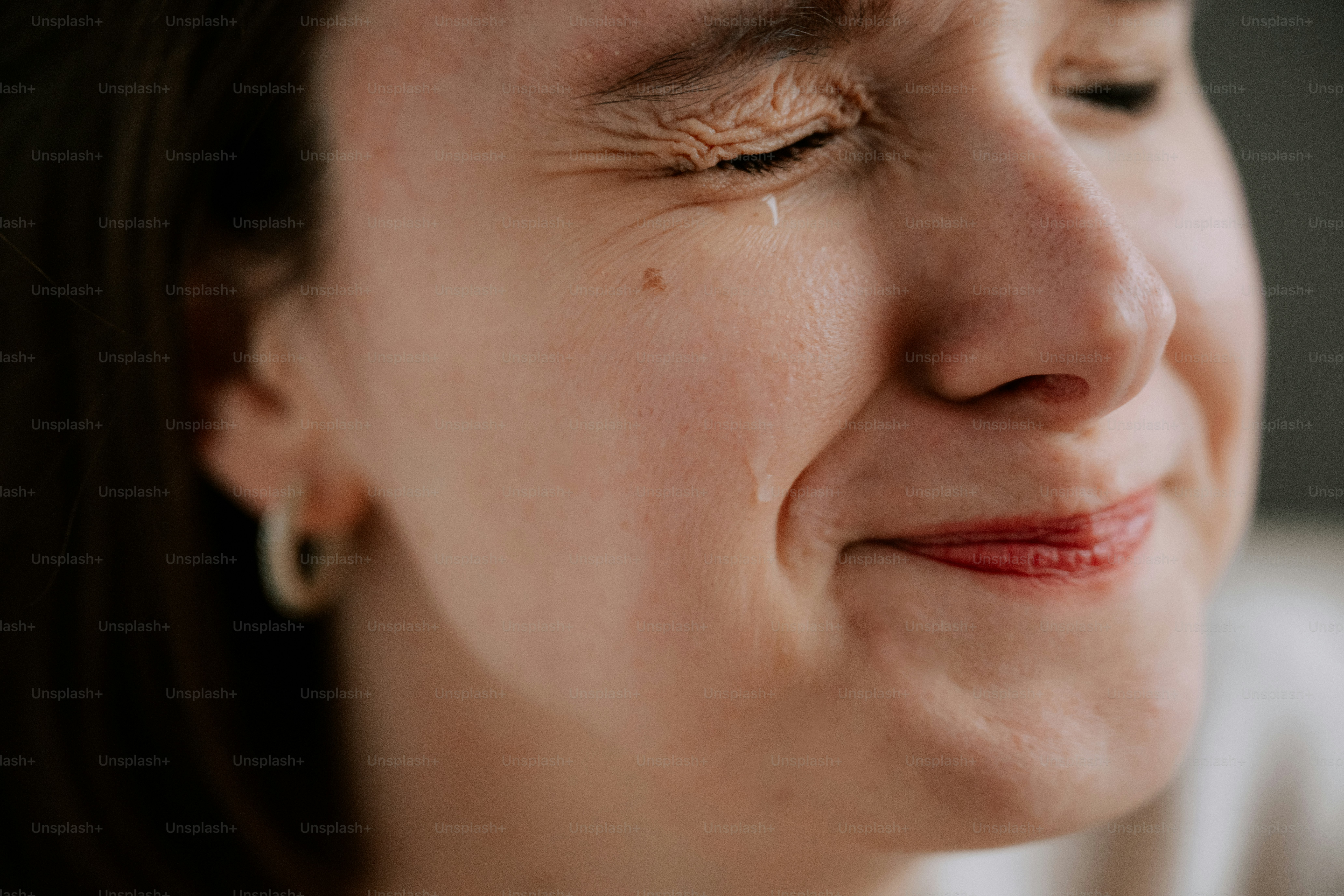 The woman is visibly crying and appears sad.
