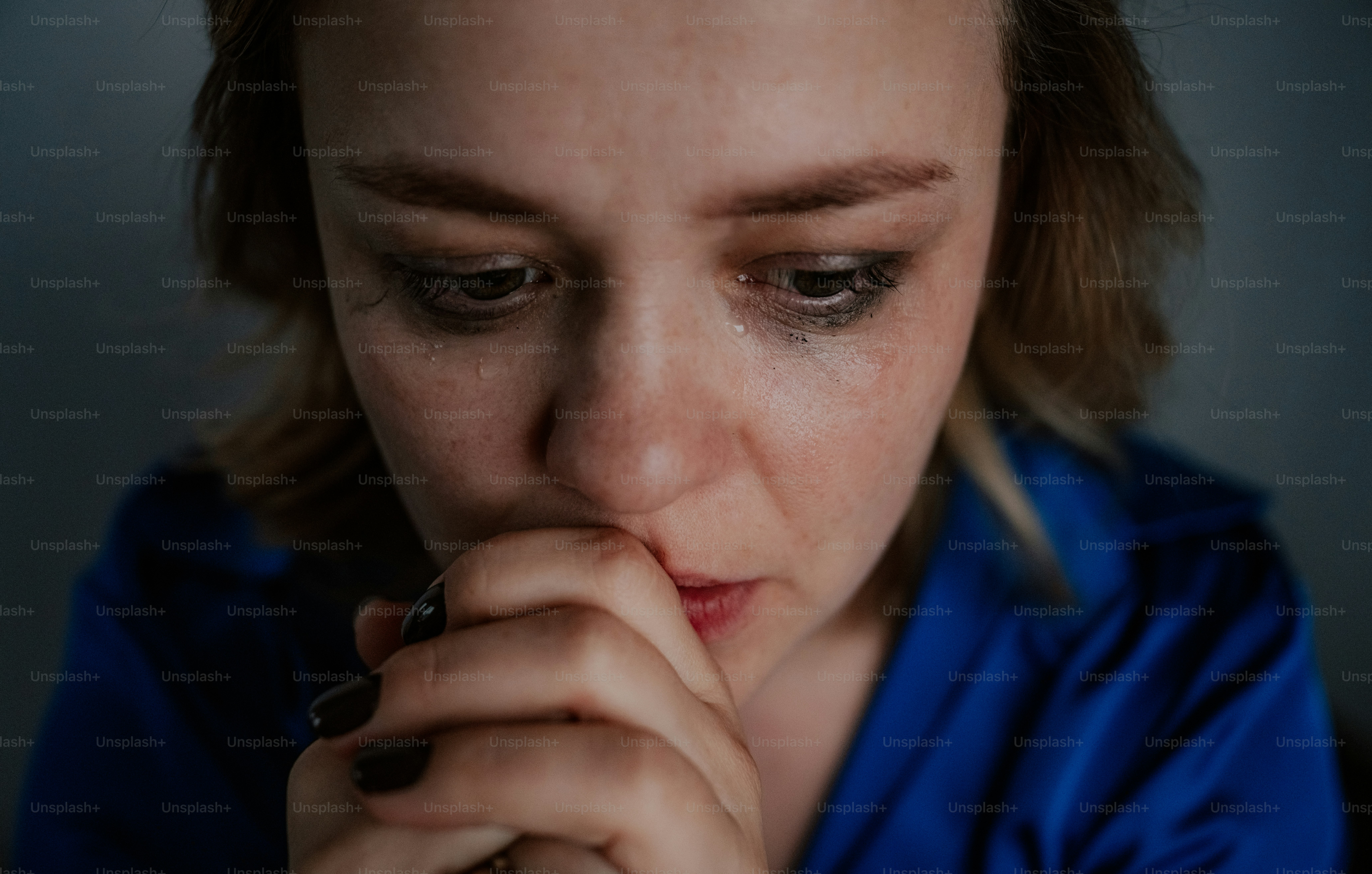 A worried woman appears to be contemplating something.