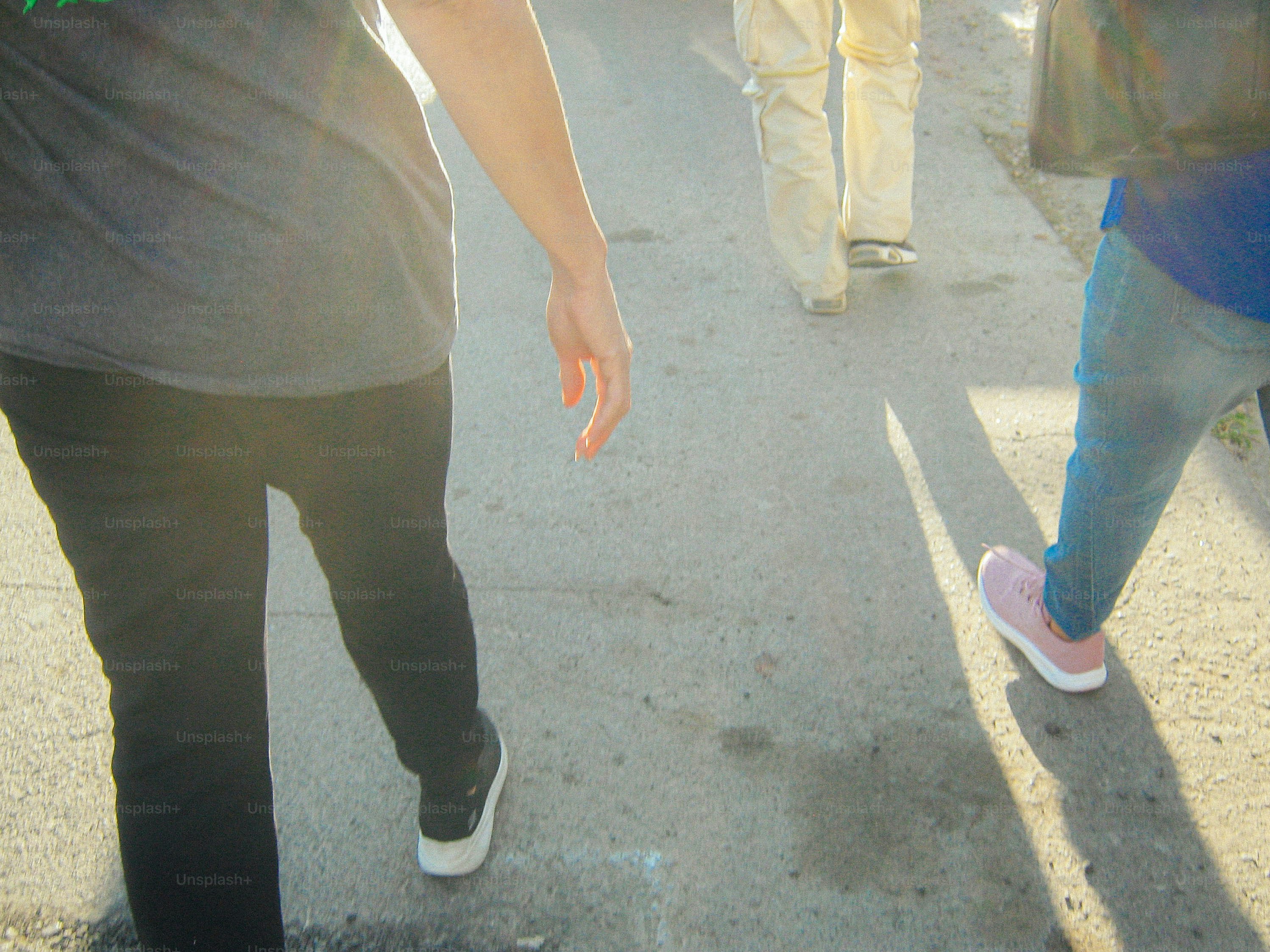 People are walking together on the pavement