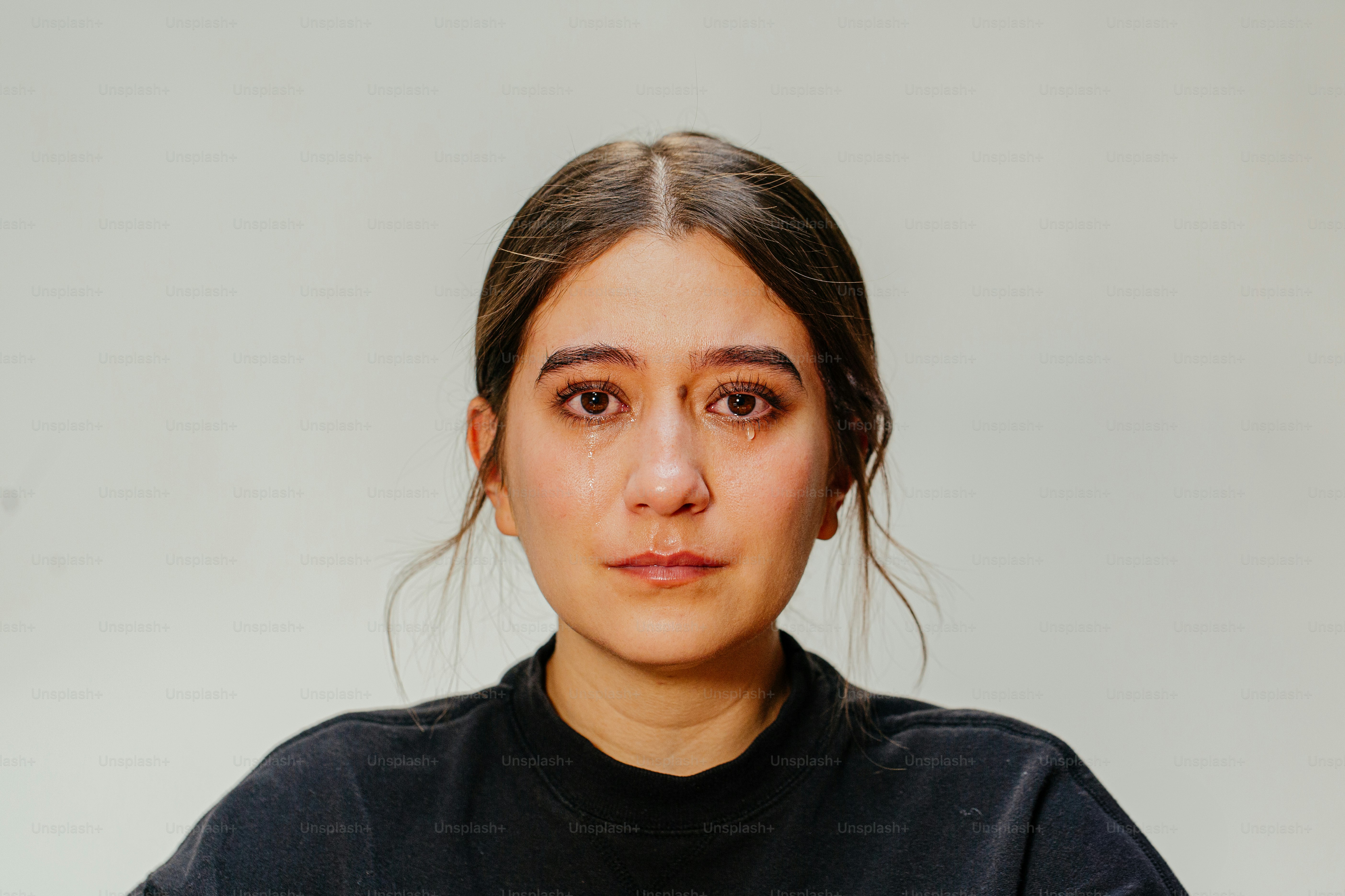 A young woman is looking directly at the camera.