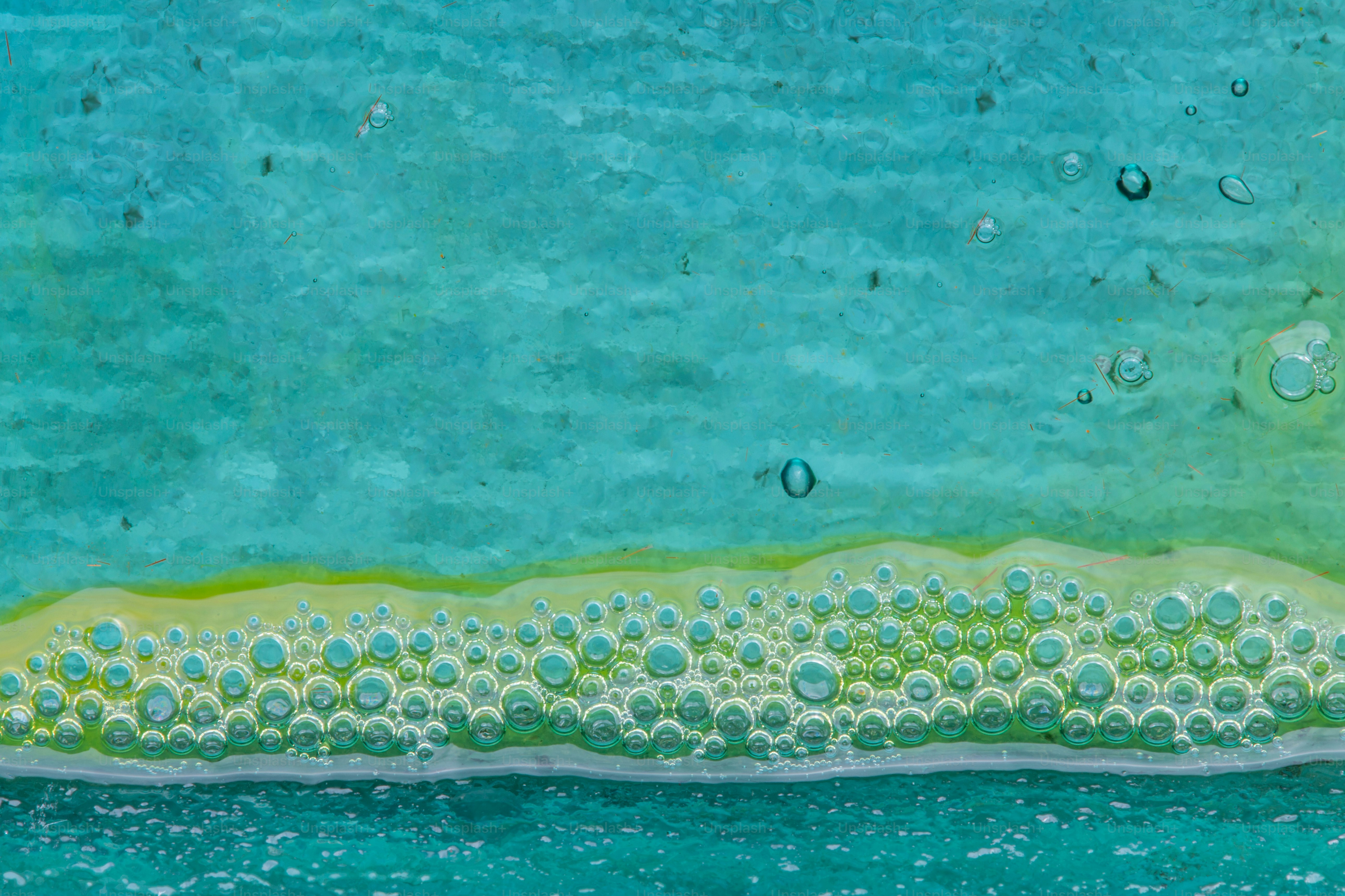 Fondo abstracto pintado de azul y verde con burbujas.