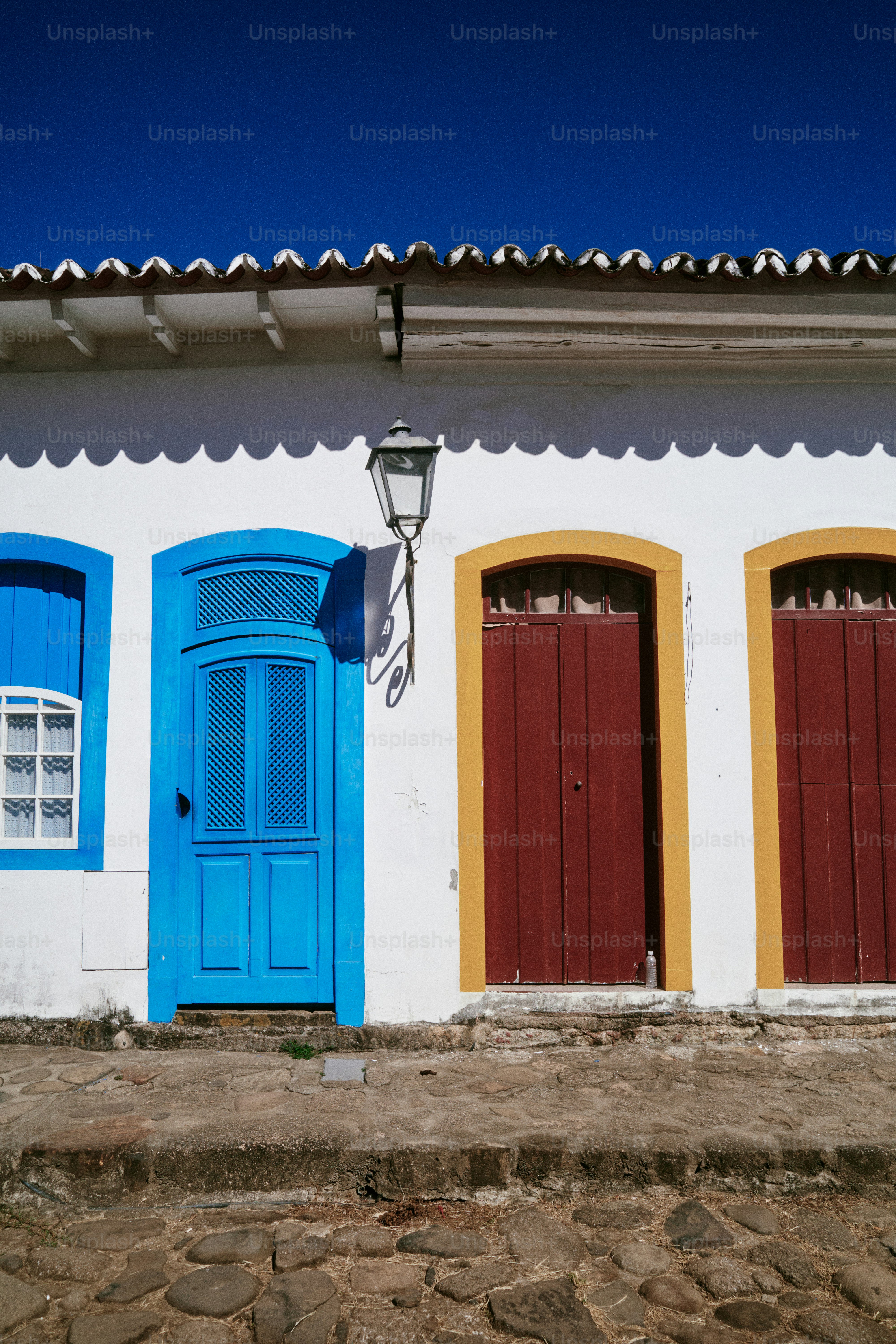 Colorful doors and windows on a white building.
